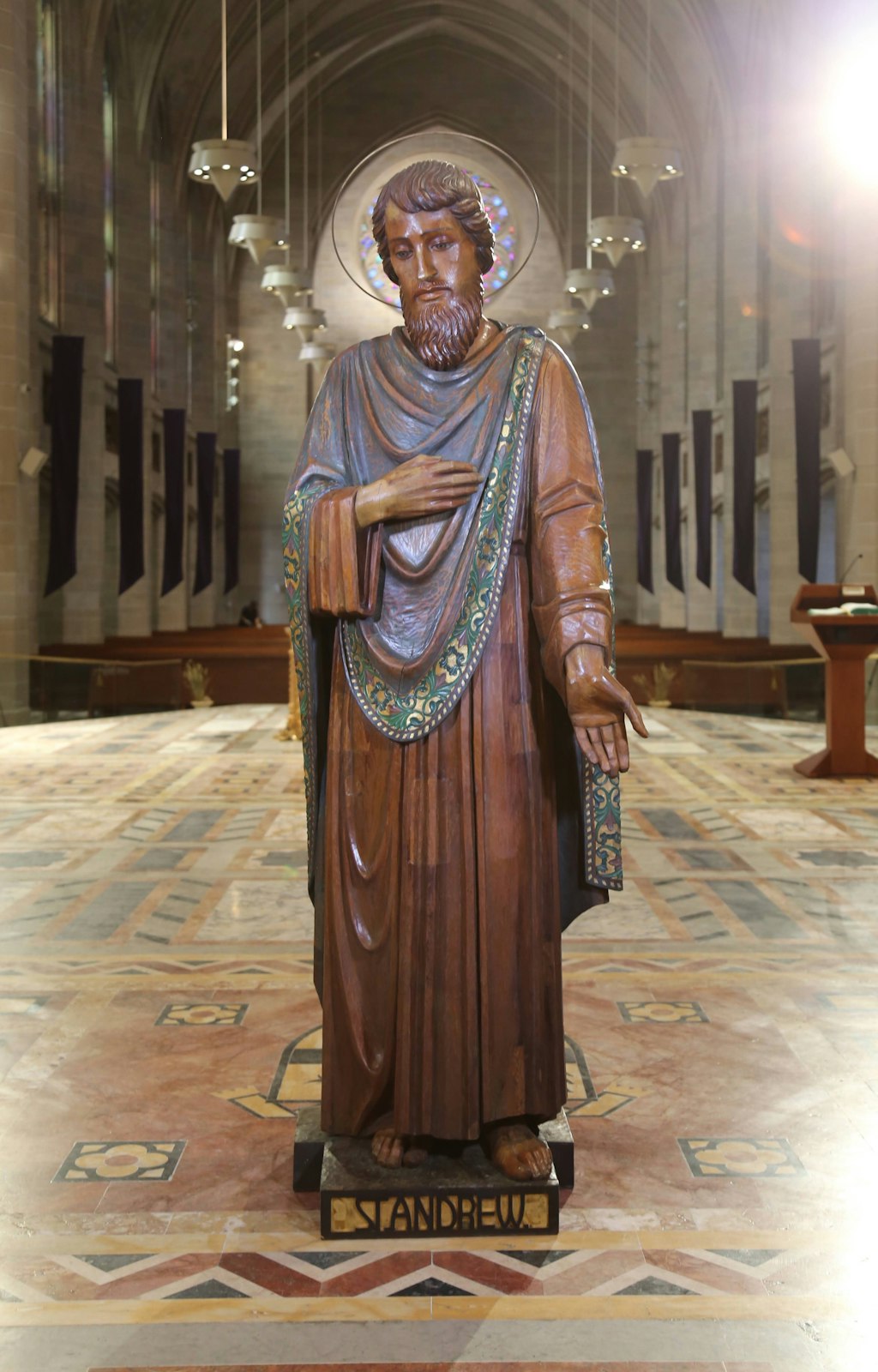 The statue of St. Andrew is pictured. Each of the statues were carved from a single tree trunk and were rescued from St. Benedict Church in Highland Park, which closed in 2014. After undergoing extensive restoration, the statues were installed in the cathedral's nave in December.