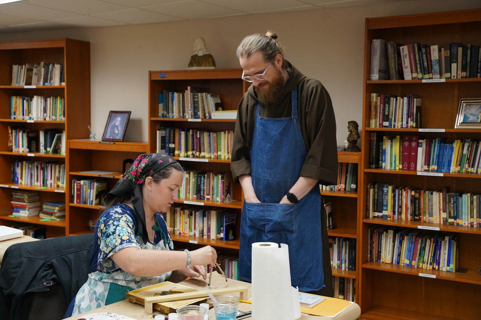 Bro. Skowron offers feedback and pointers as a participant completes her icon July 12, the final day of an iconography retreat at the Capuchin Retreat Center.