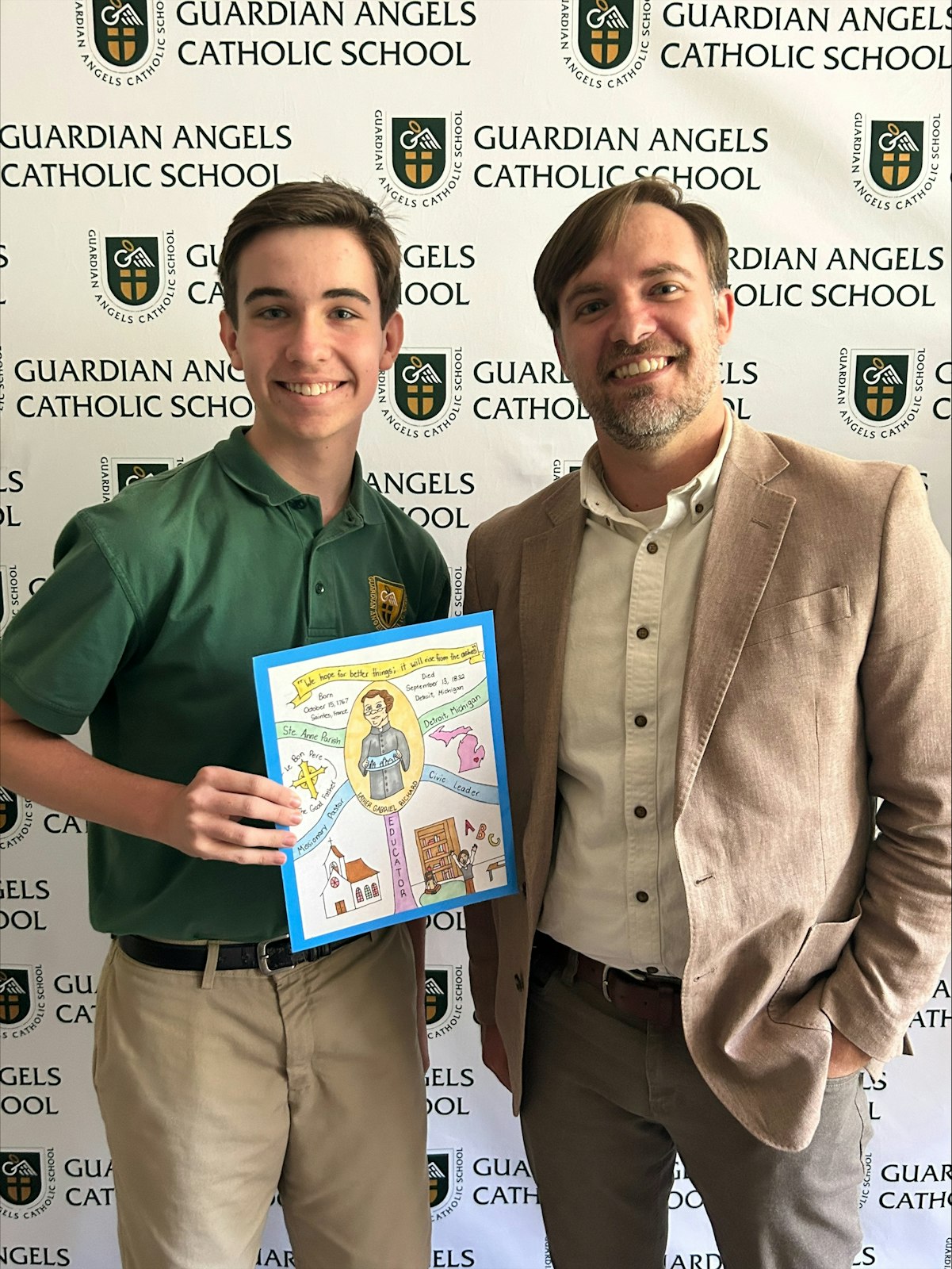 Jack Bishop, an eighth-grader at Guardian Angels School in Clawson, holds his winning entry next to Father Gabriel Richard Guild President Joe Boggs.