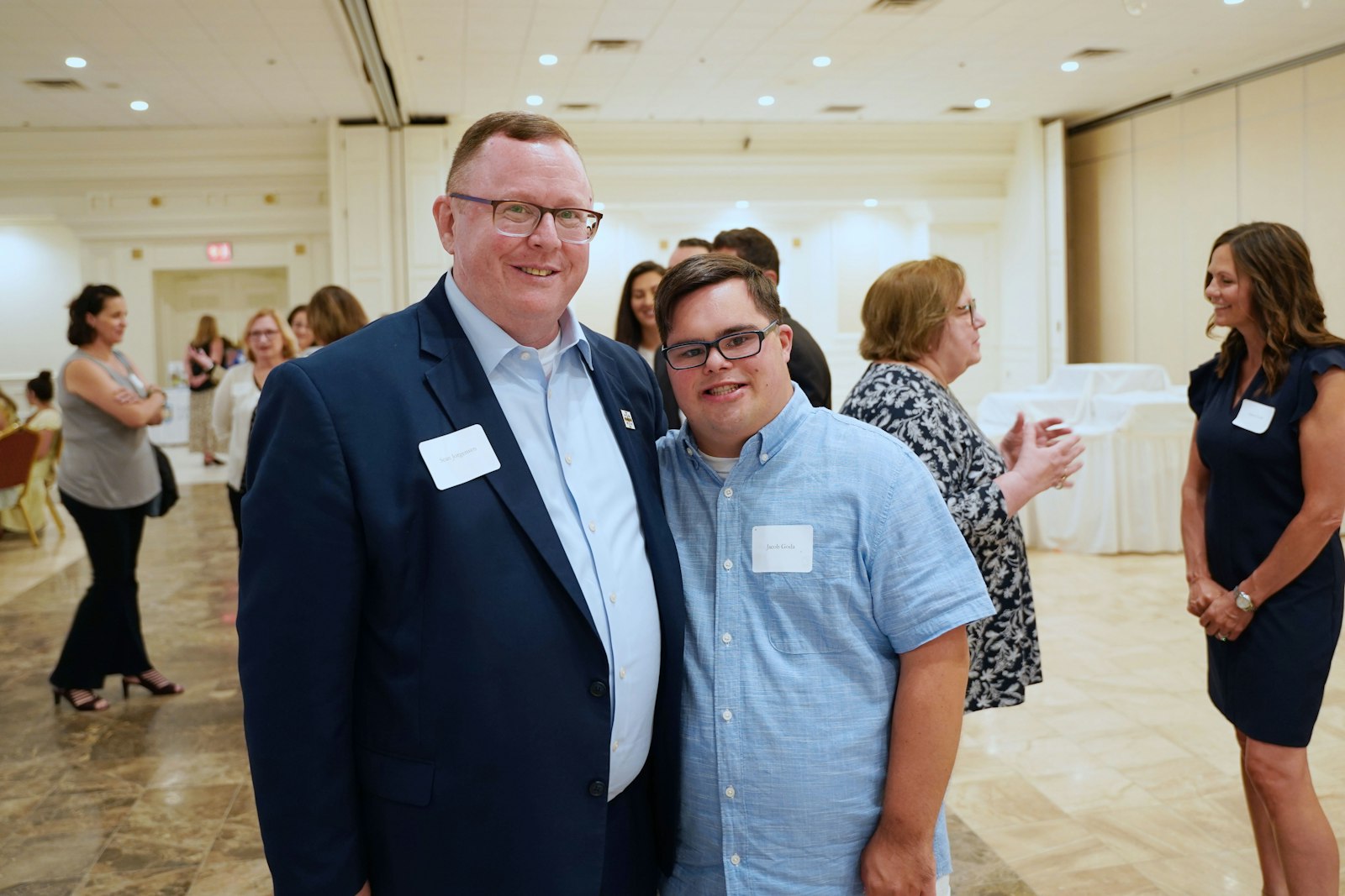 St. Mary Catholic Central president Sean Jorgensen poses for a photo with Jacob Goda, a graduate of the school's St. Andre Bessette Open Door Inclusion Program, during a benefit dinner for the new St. Margaret of Castello Granting Fund, which seeks to support programs like St. Mary Catholic Central's in Catholic schools throughout the Archdiocese of Detroit. (Daniel Meloy | Detroit Catholic)
