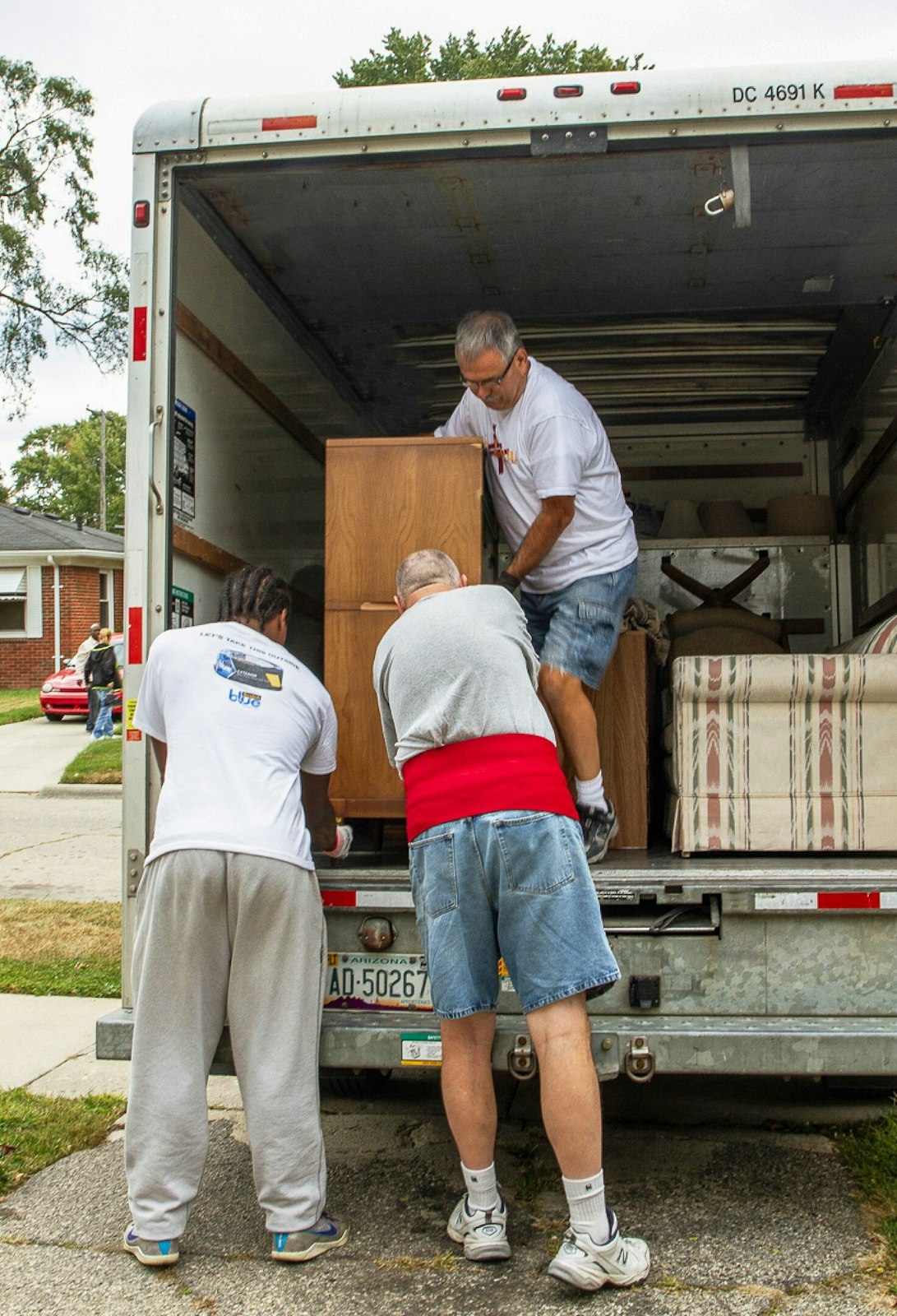 Volunteers help a resident move into her new home. Connie Borg, executive director of Journey to Housing, said the program is unique in that it seeks to address the root causes of "hidden homelessness" in the community.