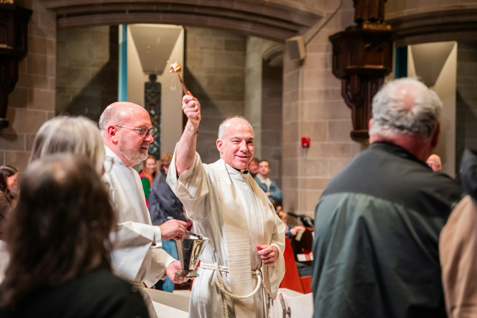 Cathedral rector Fr. J.J. Mech blesses the congregation with holy water during the dedication service. Fr. Mech's vision for the project started several years earlier, and included the rescue of the statues from the closed St. Benedict Church in Highland Park.