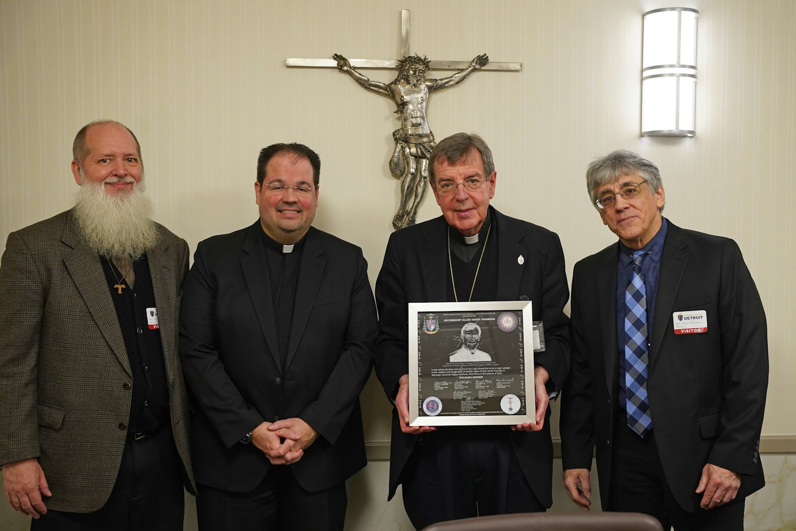 Detroit Archbishop Allen H. Vigneron accepts a gift from representatives of the Archdiocese of Detroit's Legion of Mary in gratitude for the archbishop's support of the apostolate's efforts to promote and foster the growth of several new Legion of Mary youth praesidia in Ghana. Pictured from left are Scott Cheney, president of the Detroit Regia of the Legion of Mary; Fr. Craig Marion; Archbishop Vigneron; and Steve Badalament, recent past president of the Detroit Regia. (Daniel Meloy | Detroit Catholic)