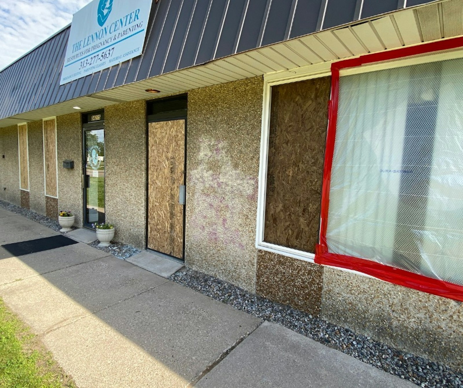 Windows are doors are boarded up at the Lennon Pregnancy Center in Dearborn Heights. In the last month, the center said it has helped 97 individuals, which included 232 boxes of material goods and 280 packages of diapers, among other services.
