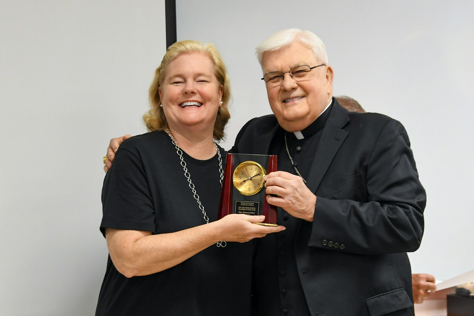 Bishop John M. Quinn presents the 2024 Bishop John M. Quinn Secondary School Teacher of the Year Award to English teacher Marylee Petty at Bishop Foley High School in Madison Heights. (Kaitlyn Grace Chornoby | Special to Detroit Catholic)