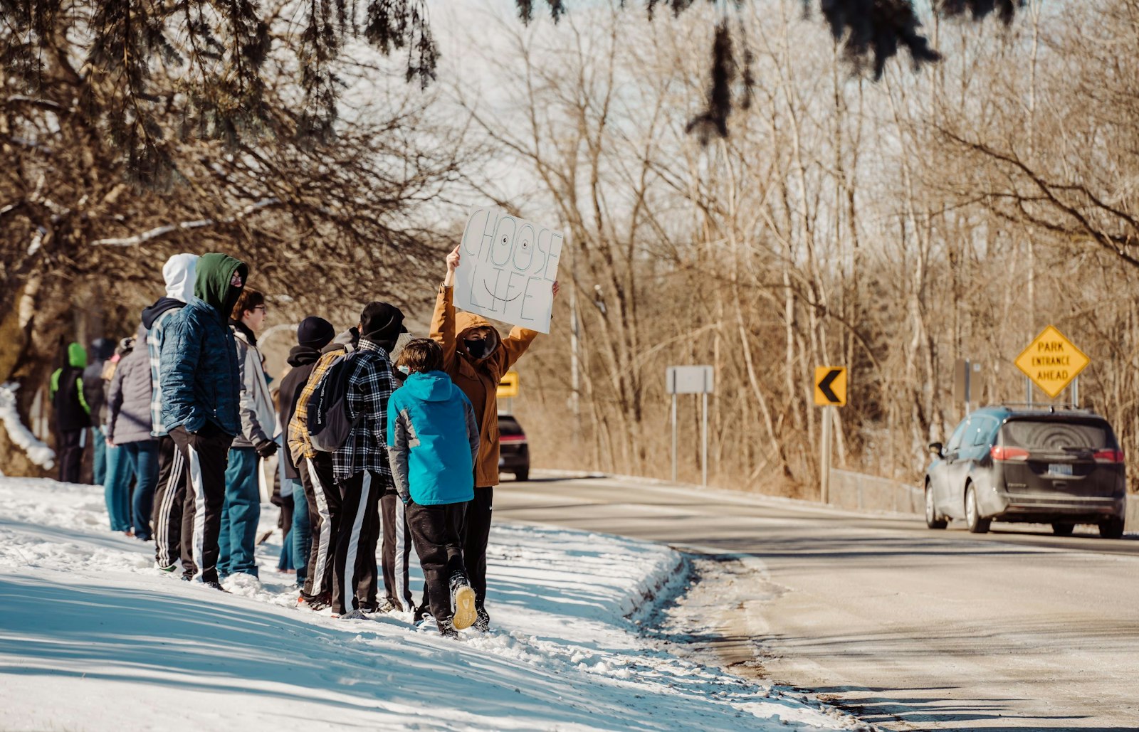 Everest Collegiate students hold signs for drivers passing by the school during a pro-life rally last year. (Valaurian Waller | Detroit Catholic)