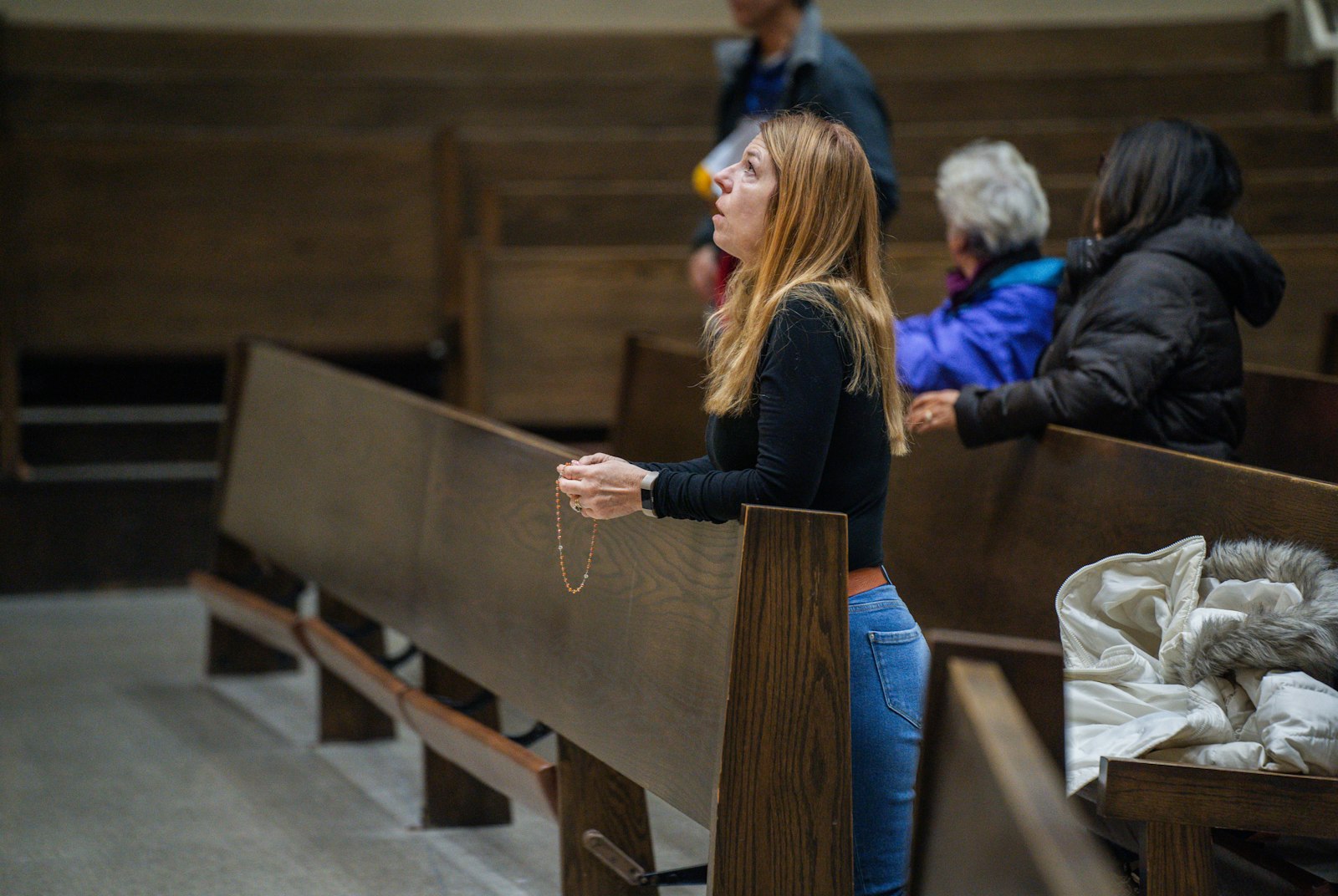 A woman prays the rosary for the unborn and vulnerable during a Mass for Life on Nov. 8, 2023, at St. Mary's Cathedral in Lansing. (Valaurian Waller | Detroit Catholic)