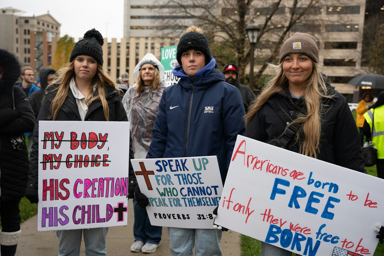 Students hold pro-life signs while braving the rain on the Capitol lawn in Lansing during the first-ever Michigan March for Life on Nov. 8, the one-year anniversary of the passing of Proposal 3.