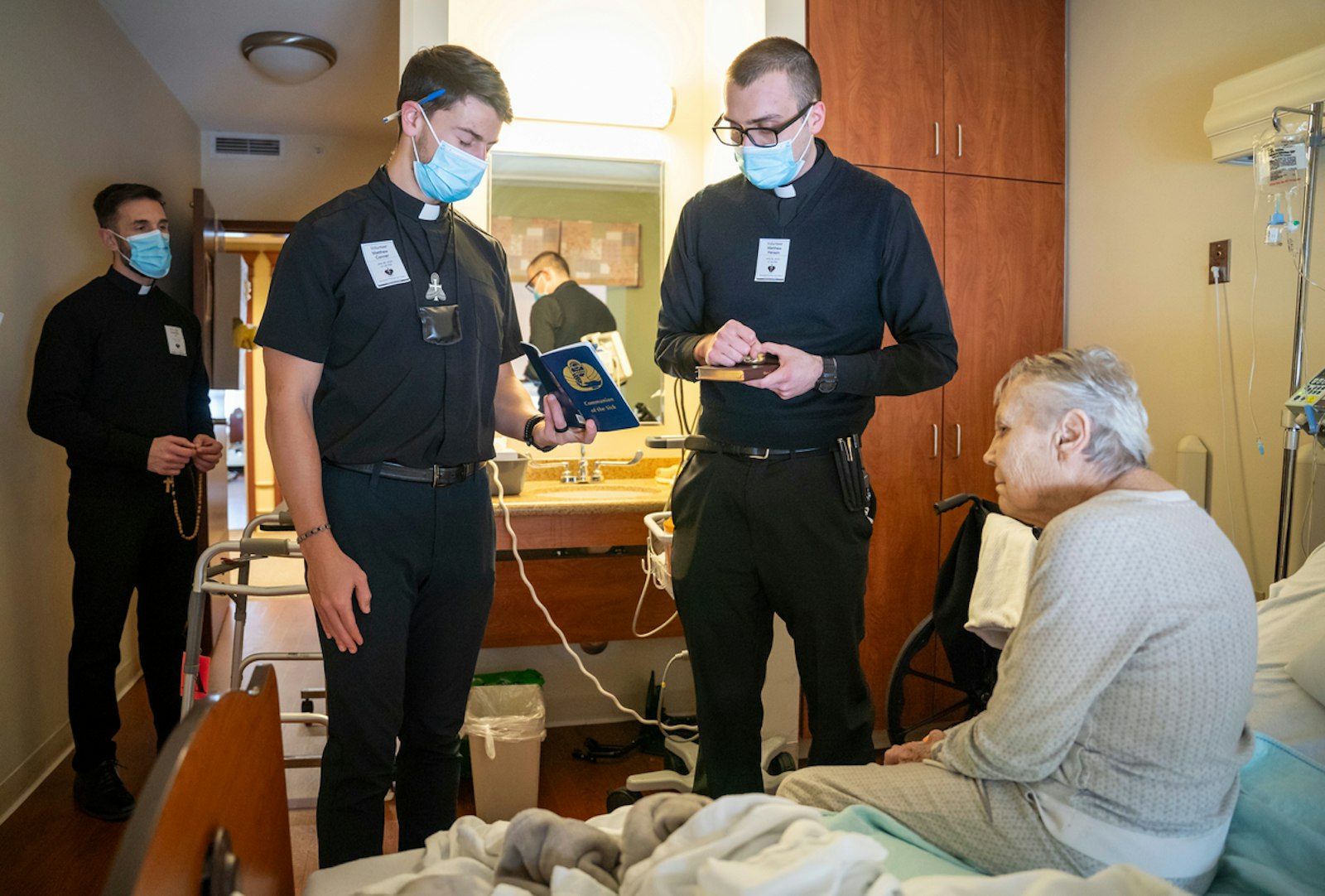 Seminarians offer Communion to homebound residents at Marywood Nursing Care Center in Livonia.