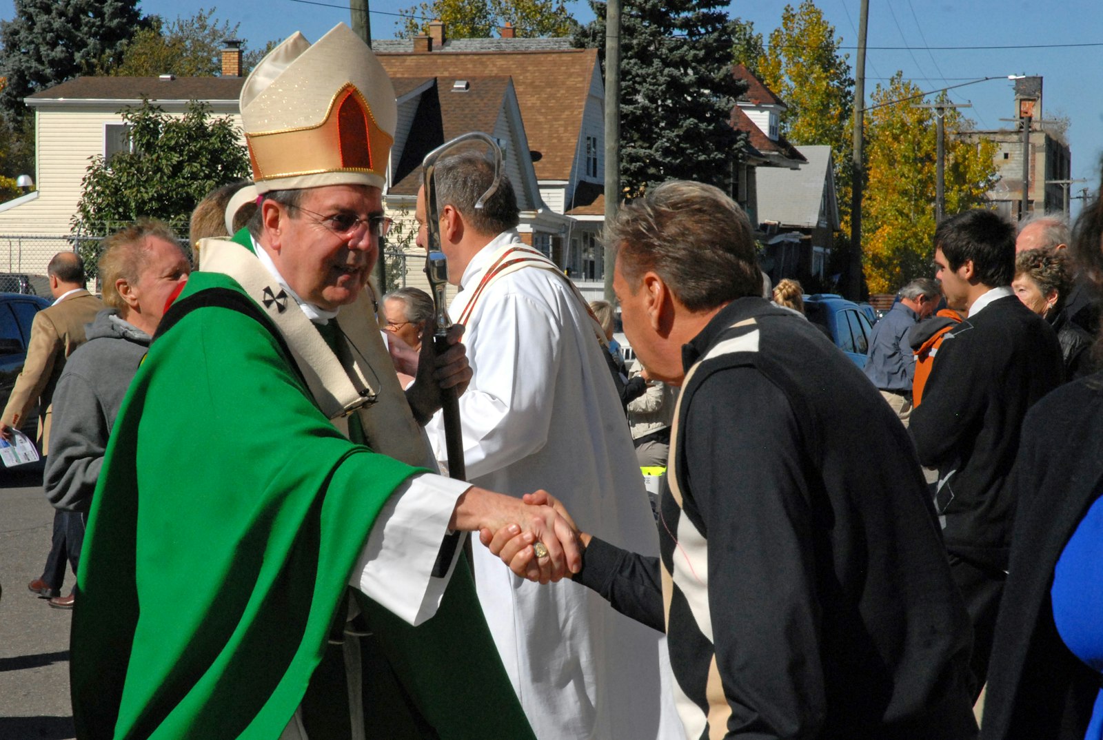 Archbishop Vigneron greets Massgoers outside of St. Francis D'Assisi Church in Detroit following a "Mass mob" in October 2014, a grassroots movement of lay Catholics supporting historic inner-city churches. (Jonathan Francis | Archdiocese of Detroit)