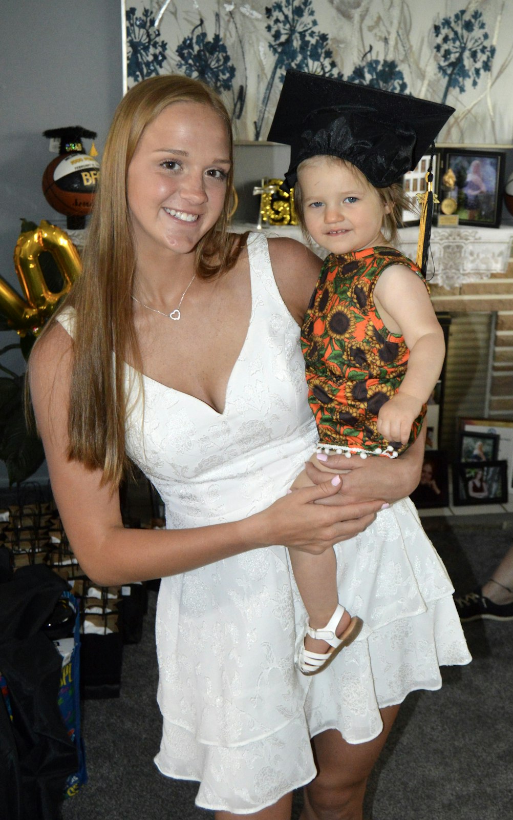 Melanie Moore (Class of 2022) holds her cousin, Emma Doxen, who may be the next Bishop Foley Catholic High School graduate in the Wardowski family to span another decade.