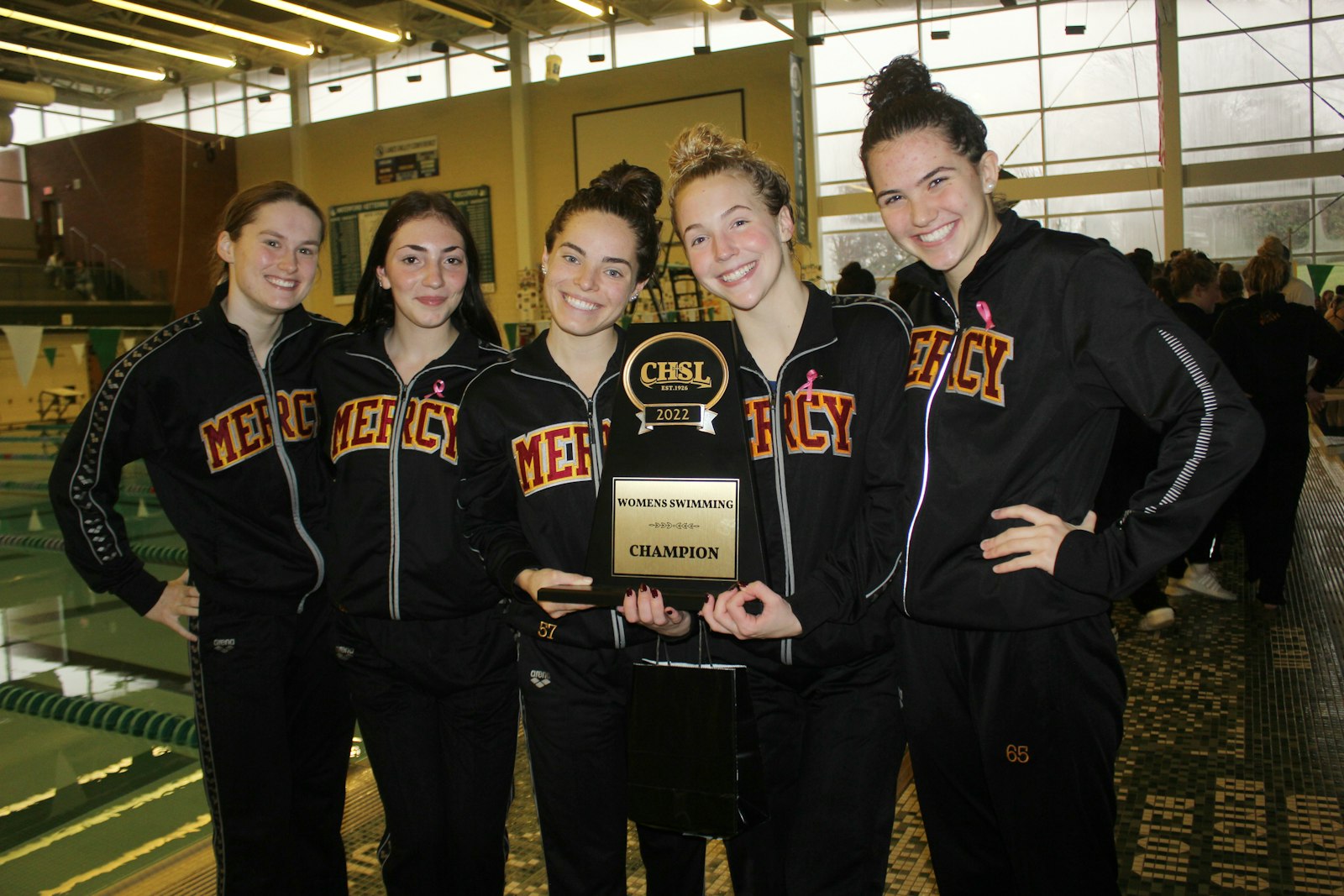 Farmington Hills Mercy swimming and diving team captains Grace Roberts, Bella D’Orazio, Elizabeth Bayer, Alexis Conway and Sydney Derkervorkian hoist yet another Catholic League championship trophy. The Marlins have won the league meet every season since 1991.