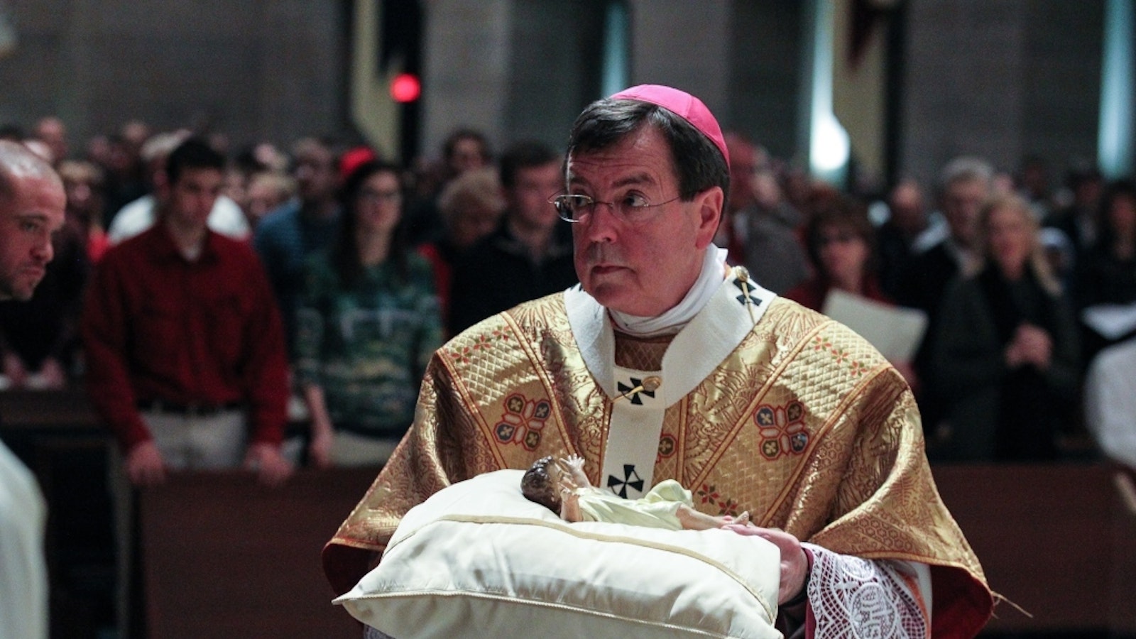 Archbishop Vigneron carries the Christ Child to the manger during Midnight Mass on Christmas Eve, Dec. 24, 2012, at the Cathedral of the Most Blessed Sacrament. (Larry A. Peplin | Detroit Catholic file photo)