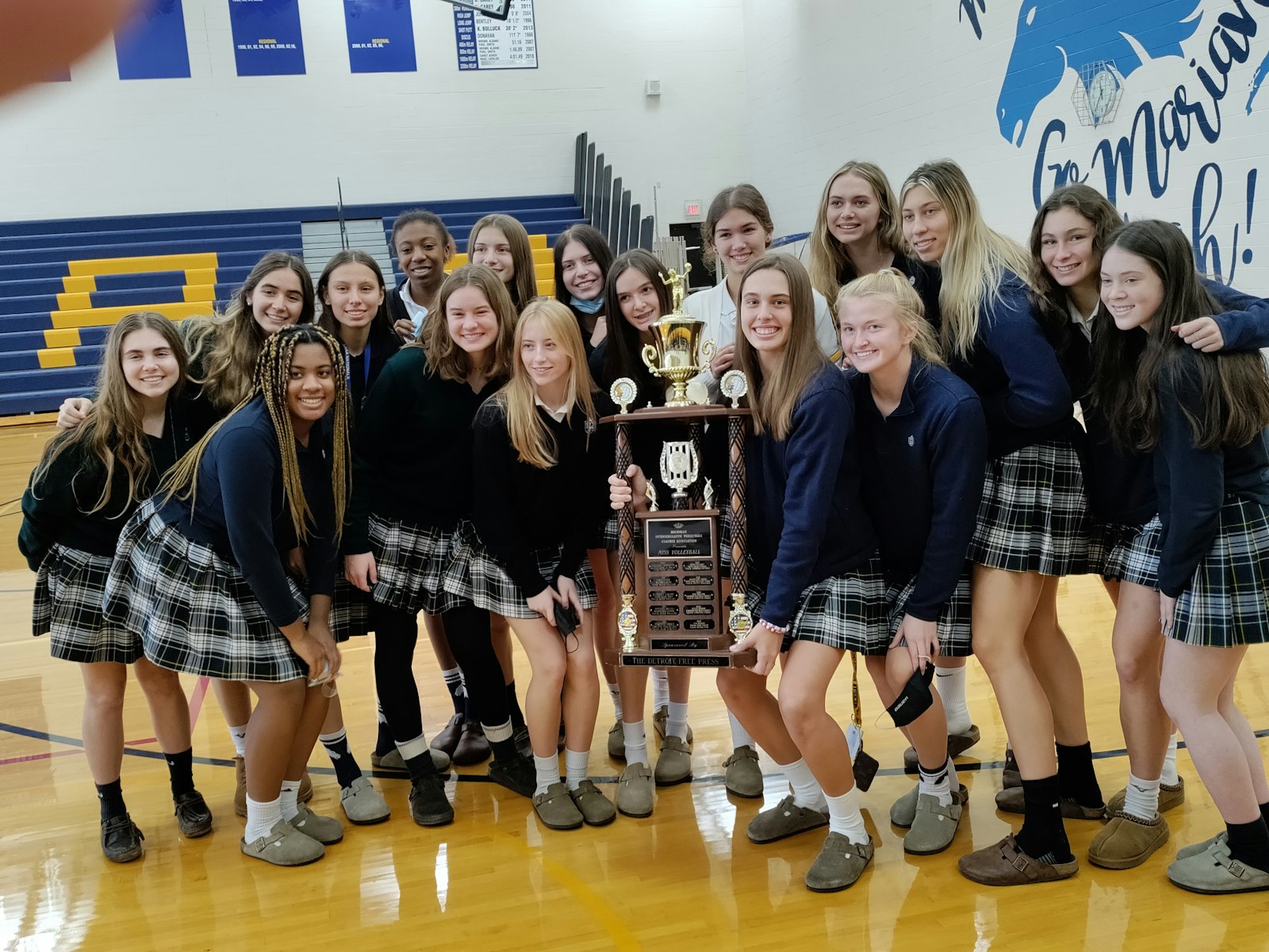 Ava Brizard’s teammates celebrate her winning the 2021 Miss Volleyball award. They are on the threshold of repeating as Division 1 state champion. The Mustangs have a semi-final match at 4:30 p.m. Thursday against Hudsonville.