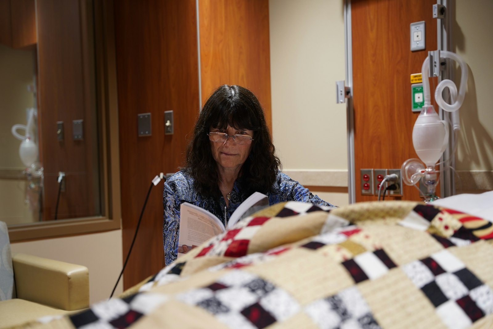 Lisa Marie Blanek, a No One Dies Alone volunteer, reads a book bedside of a patient. The No One Dies Alone program has volunteer read to terminally-ill patients, play music or just hold hands with people as they near death. The program ensures no patient at Trinity Health’s Livonia and Pontiac hospitals dies without anyone else in the room.