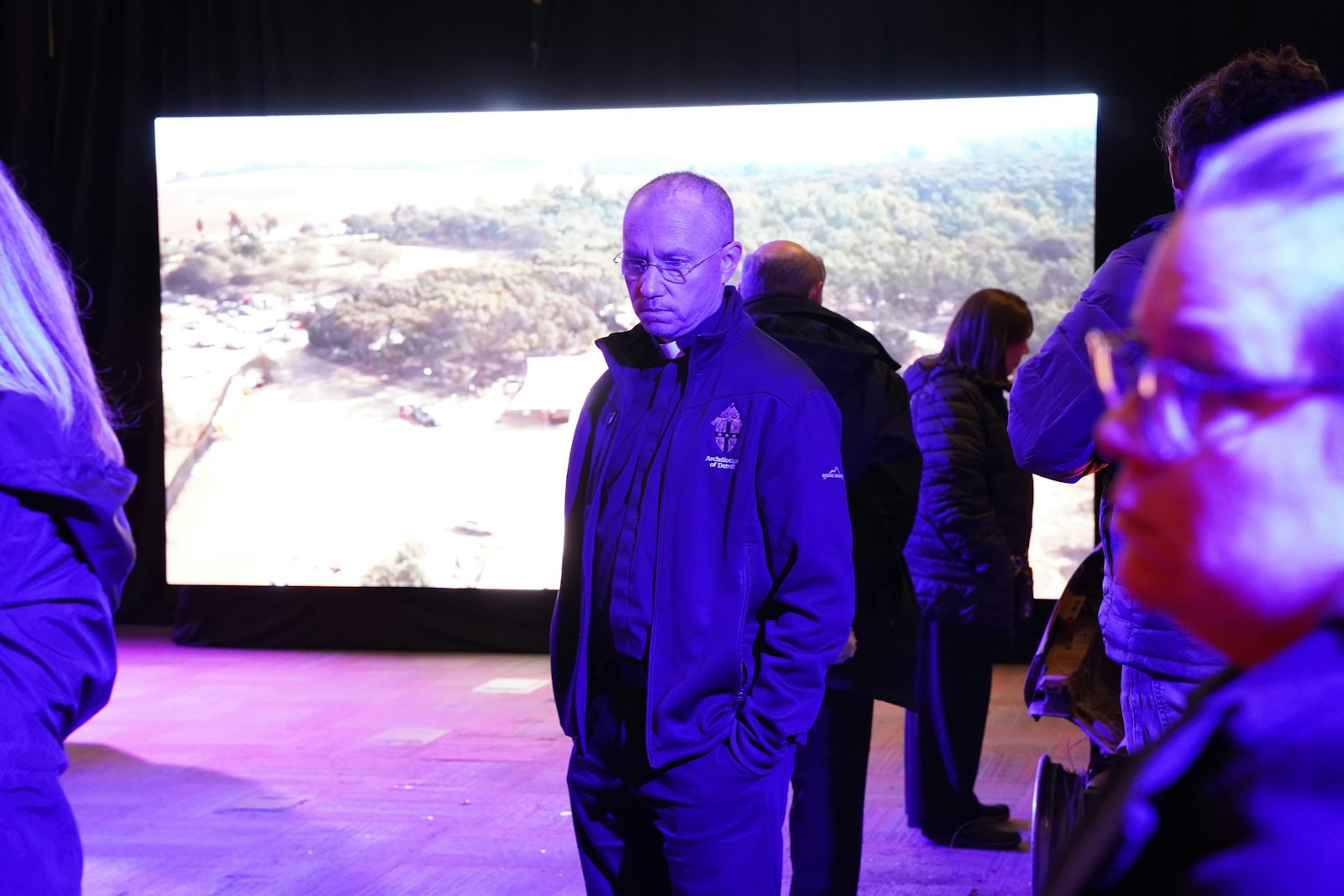 Fr. Andrew Dawson of Prince of Peace Parish in West Bloomfield takes in the Nova exhibit at The J. The exhibit features videos recording the sudden and brutal nature of the attack, along with objects from the attack, such as portable toilets with bullet holes and burned-out vehicles.