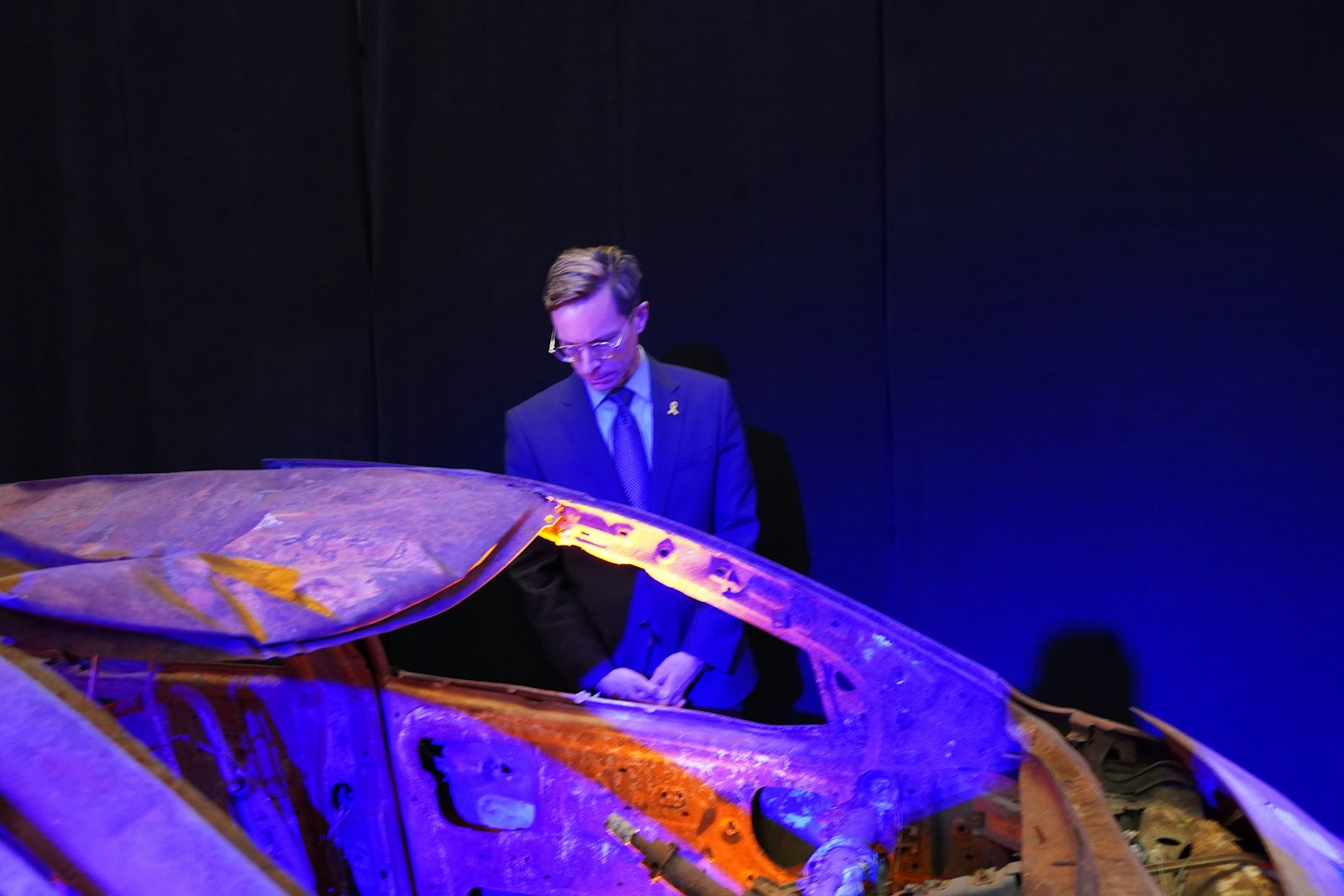 David Conrad, coordinator of ecumenical and interfaith relations for the Archdiocese of Detroit, views a burned-out car that is part of Nova: The Moment Music Stood Still, a national pop-up exhibition touring the country, telling the story of the Oct. 7, 2023, Hamas terrorist attack on a music festival in southern Israel.