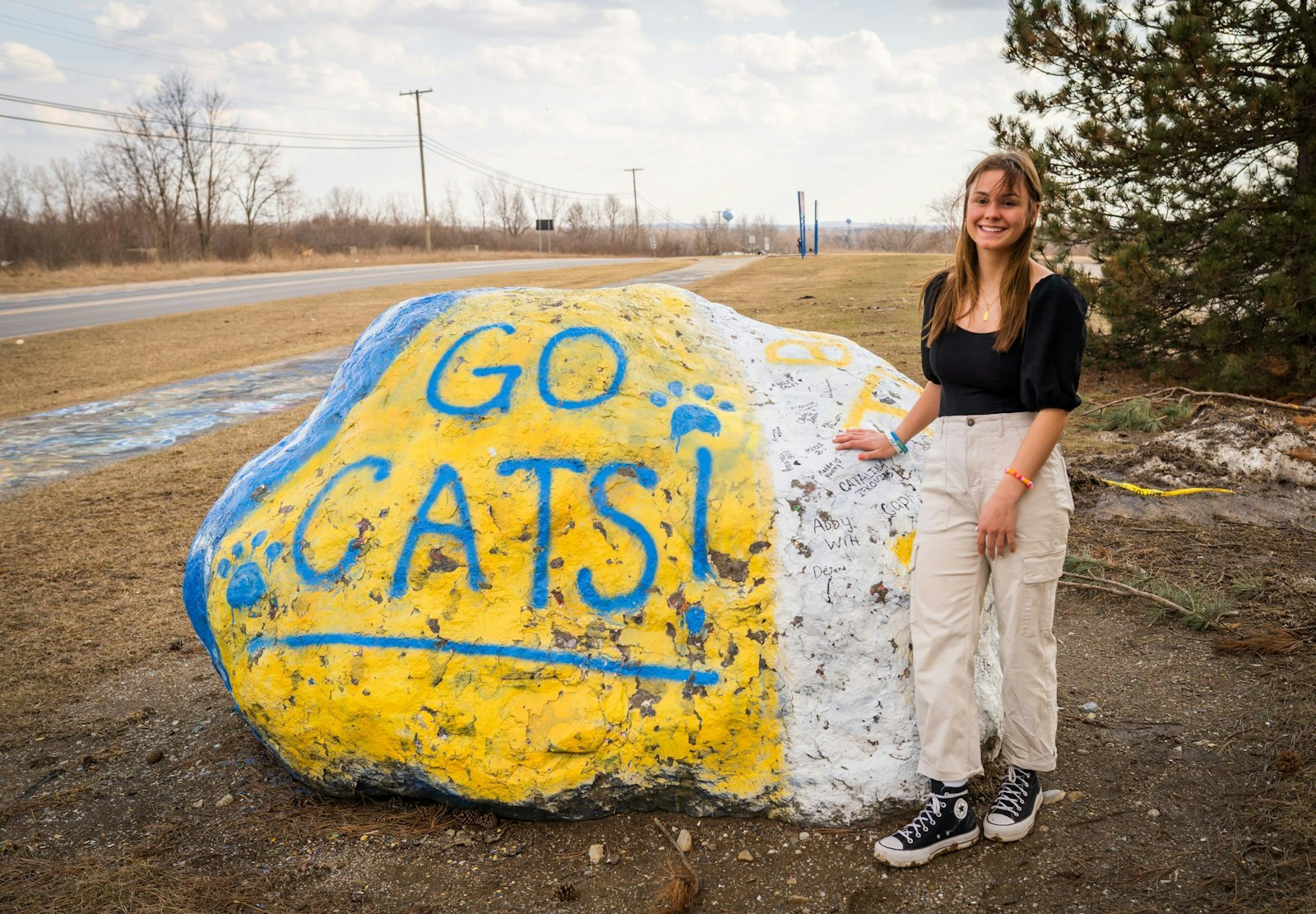LeeAnn Johnson is pictured near the Oxford High School "rock," which students paint as an annual tradition. Though Johnson is leaving Oxford to pursue her college studies in biochemistry, she says she'll continue to use her experience to help others struggling with trauma and doubt to find faith in a God who loves them.
