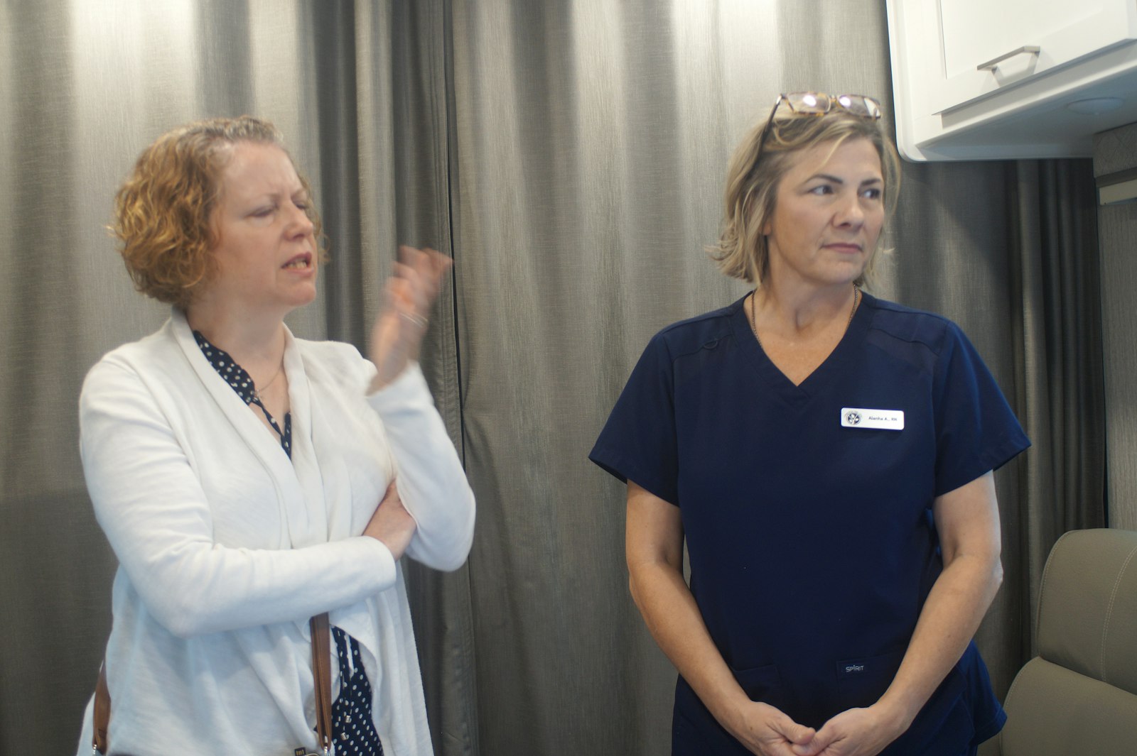 Amiee Godfrey, director of Catholic Charities for the Diocese of Lansing, and nurse Alanha Asher talk with a reporter inside the new Mobile Medical Unit of the Brighton-based Pregnancy Help Clinic.