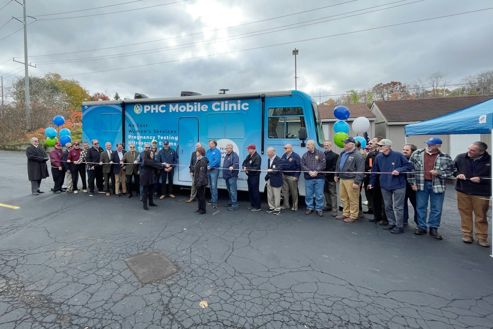 Staff, volunteers and donors line up for a ribbon-cutting ceremony for the new Pregnancy Help Clinic Mobile Medical Unit. (Courtesy photo)