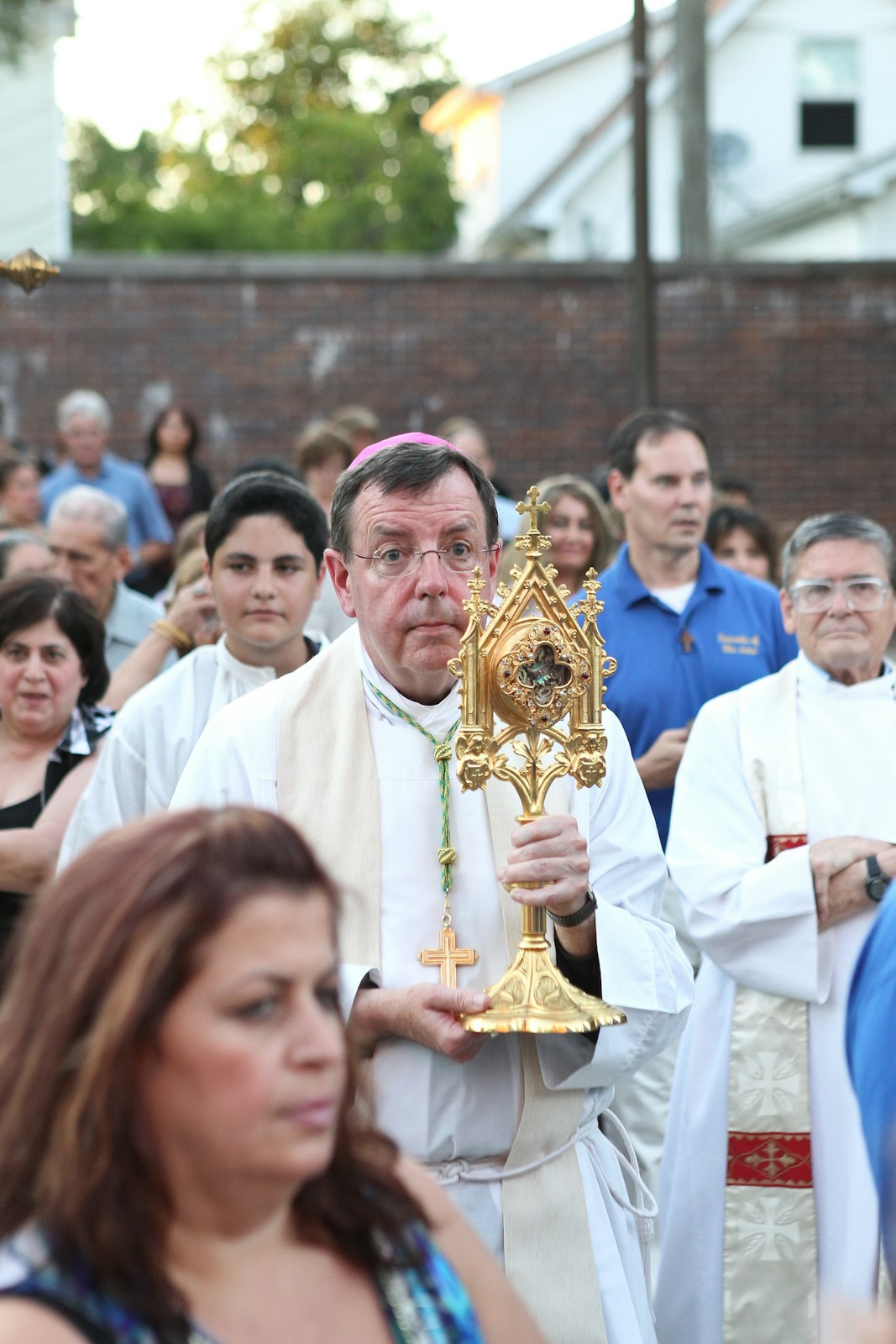 Archbishop Vigneron carries a relic of St. Anne, the grandmother of Jesus, into Ste. Anne Church in southwest Detroit on her feast day in 2011. That year, Pope Benedict XVI declared St. Anne the patroness of the Archdiocese of Detroit at Archbishop Vigneron's request. (Joe Kohn | Michigan Catholic file photo)