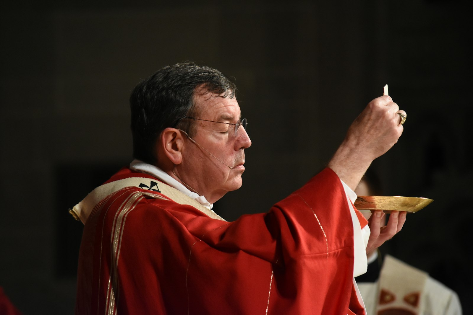 Archbishop Vigneron elevates the Holy Eucharist during a solemn Mass on the vigil of Pentecost on May 14, 2016.