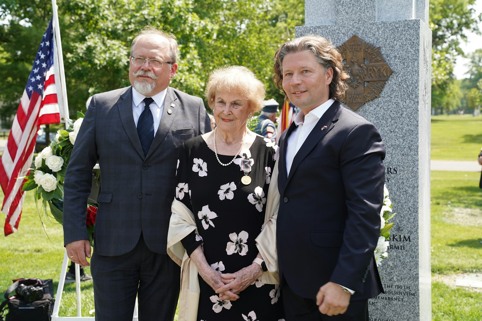 Adam Siwek, director of the Office for Commemorating of the Struggle and Martyrdom, Henrietta Nowakowski, and Arkadiusz Gorecki, former director of the Polish Mission at Orchard Lake, stand before the newly dedicated monument to the Polish Blue Army volunteers.