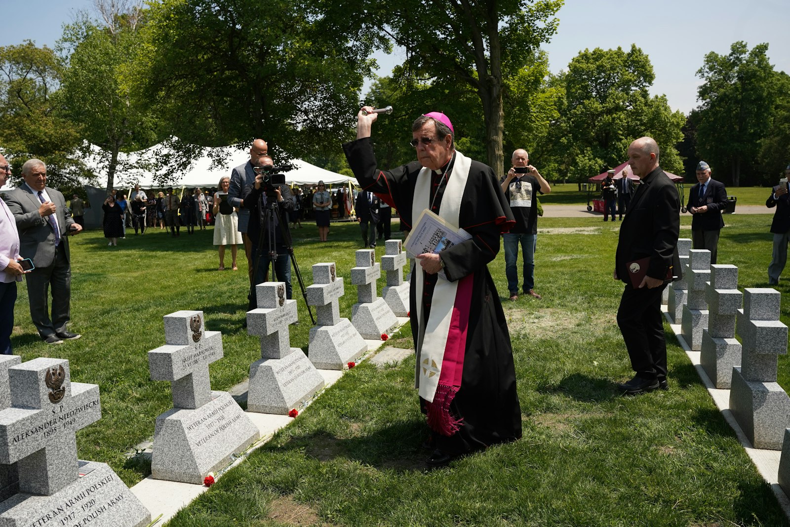 Archbishop Allen H. Vigneron blesses the 59 new grave markers commemorating the Polish Blue Army volunteers who fought in World War I for Polish independence.
