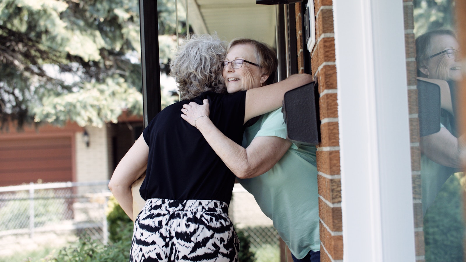 A woman hugs an elderly relative after receiving the Eucharist during Mass in a still frame from the Pope's Worldwide Prayer Network's video promoting the Holy Father's July prayer intention, "For a Eucharistic Life." The video was produced in partnership with the Archdiocese of Detroit's Department of Communications.