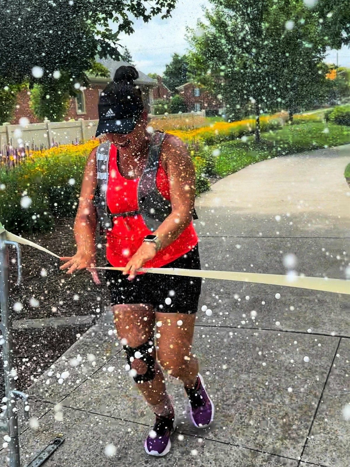 Porter is sprayed with champagne as she completes the run in St. Clair Shores’ Champine Park on Monday, July 29. (Courtesy of Nicole Lazar)