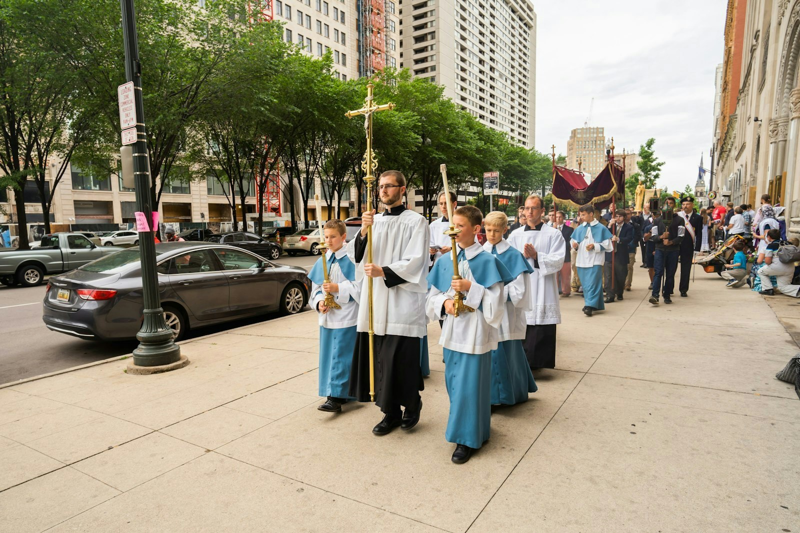 Un grupo de monaguillos lleva un crucifijo por Washington Boulevard, en el centro de Detroit, durante una procesión eucarística el Día del Padre en 2021. El proceso de alineación de la misión comenzará en marzo en la Región Central y se llevará a cabo en cada una de las cuatro regiones pastorales de la Arquidiócesis de Detroit en los próximos meses y años, dijo el Arzobispo Vigneron.