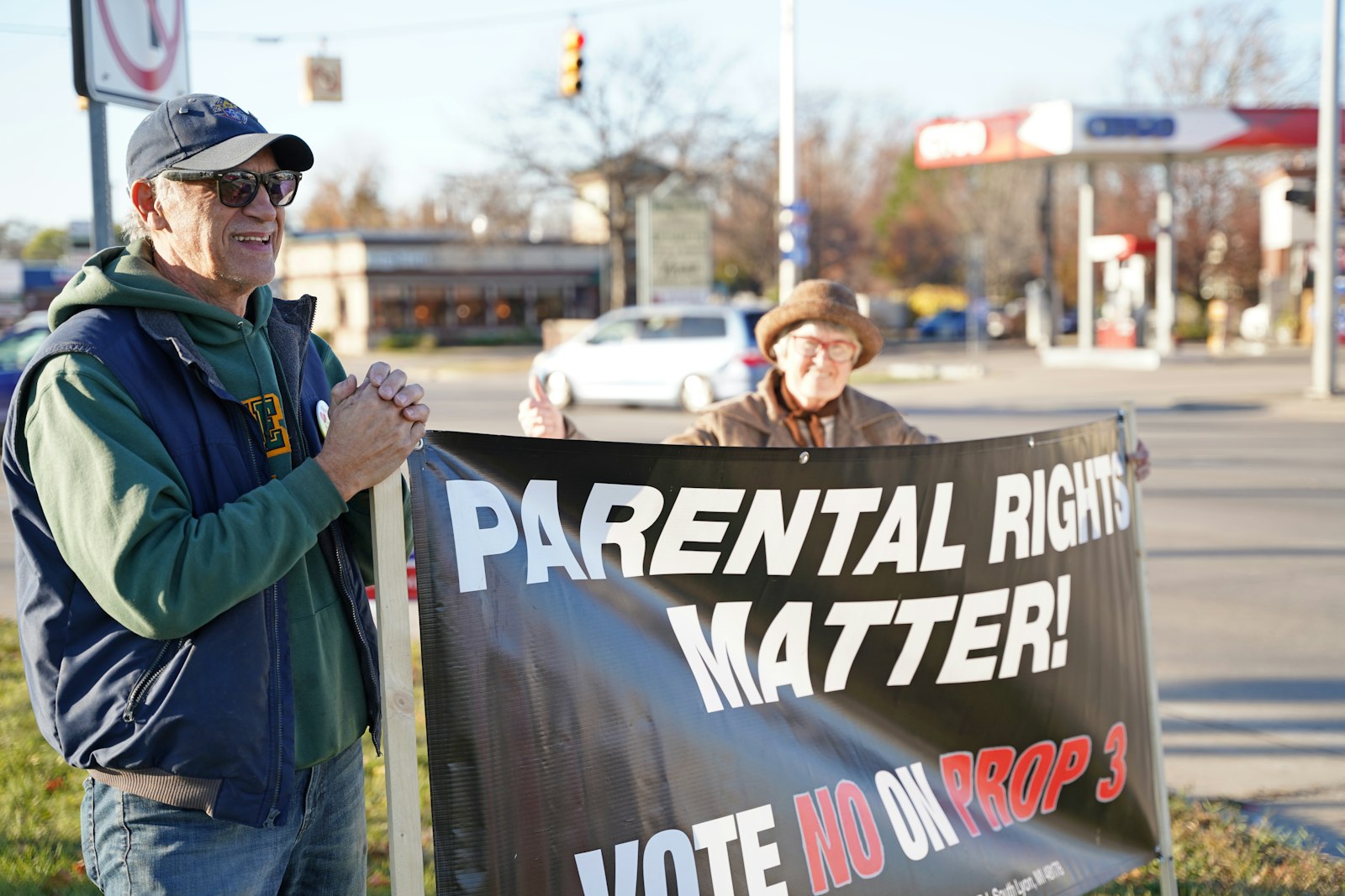 Debbie Bloomfield and Emmanuel Laghermo of Our Lady of the Scapular Parish in Wyandotte hold a sign educating voters about the ramifications of Proposal 3 at the intersection of Allen and Southfield roads in Allen Park on Nov. 7. Bloomfield said volunteers are continuing to go door to door on election day, Nov. 8, to encourage voters who might still be on the fence to vote "no."