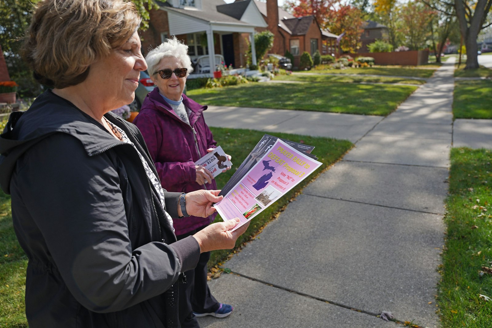 Paula Dixon, left, and Peggy Stack of the National Shrine of the Little Flower Basilica in Royal Oak, canvass a neighborhood in opposition to Proposal 3 on Oct. 14. Canvassers are encouraged to visit supportmiwomenandchildren.org to sign up to canvass, give to the "No on Proposal 3" campaign and order yard signs. (Dan Meloy | Detroit Catholic)