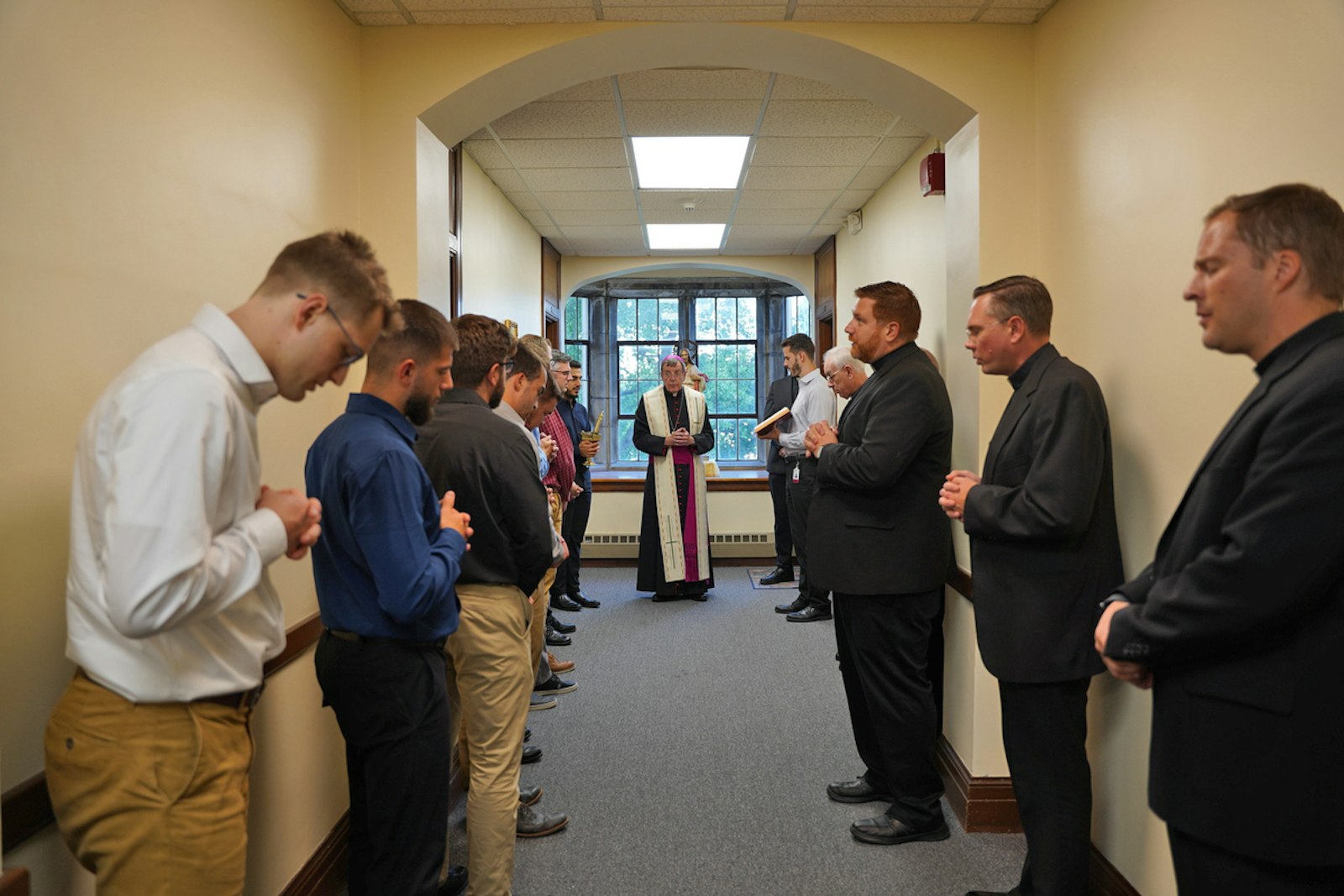 Seminarians and formators bow their heads as Archbishop Vigneron leads a prayer and blessing Sept. 19 in Sacred Heart's new John Paul II Propaedeutic Wing.