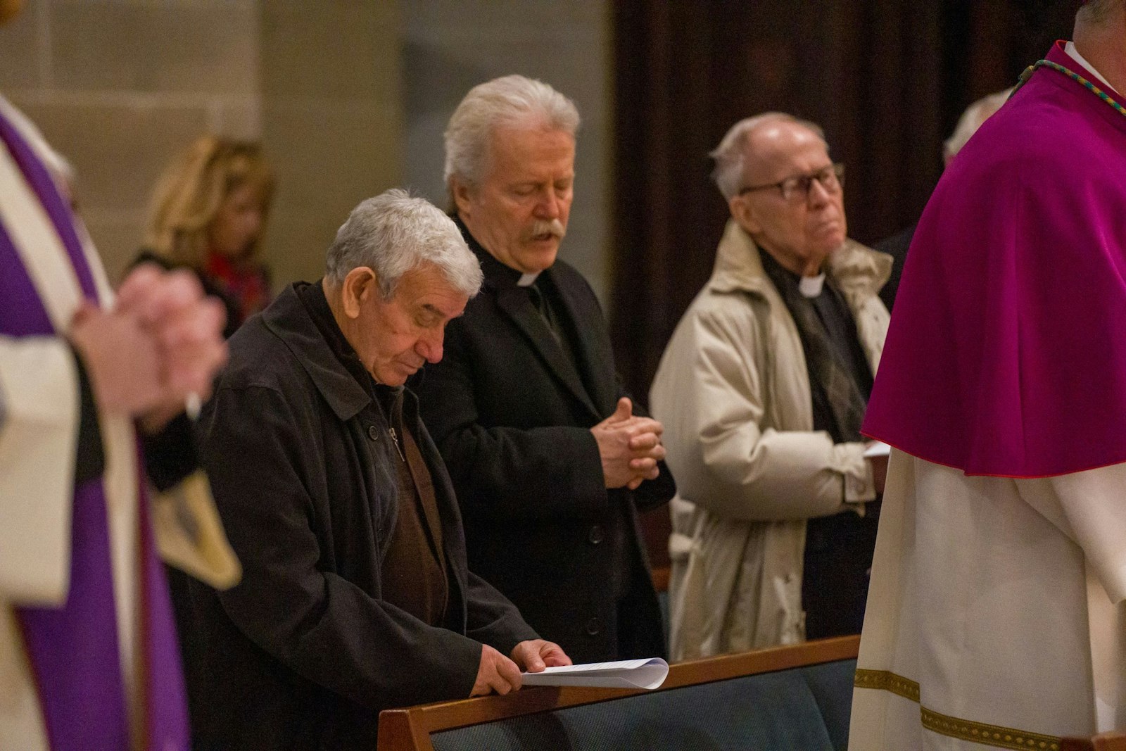 Priests of the Archdiocese of Detroit pray the consecration prayer along with the archbishop on March 25.