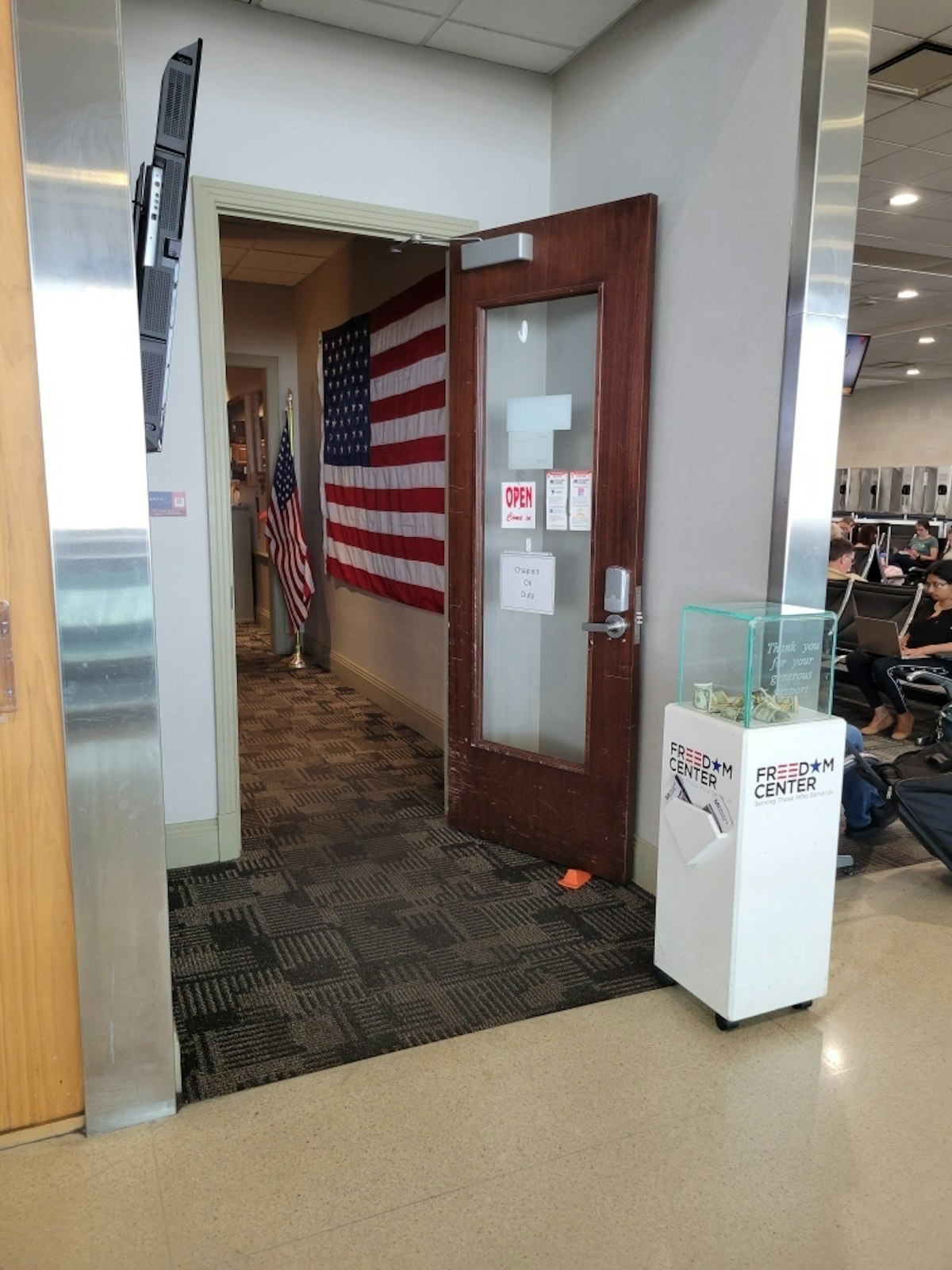 The door to the Michigan Freedom Center lounge is open for military members or their families to stop and escape the hustle and bustle of the busy airport. Deacon Van Dyke often sits near the entrance with a sign informing travelers a chaplain is available to talk, but he's careful not to impose. (Courtesy of Deacon Michael Van Dyke)