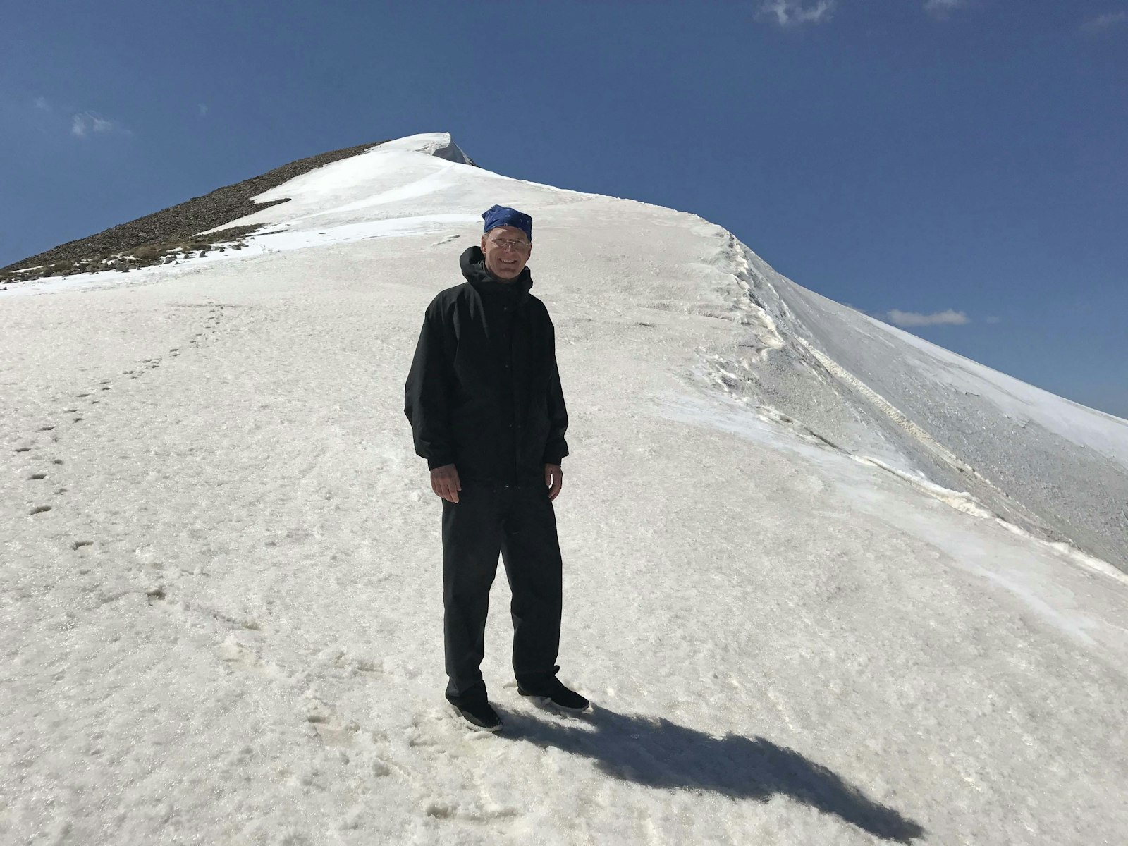 Archbishop Russell is pictured hiking to the summit of Mount Sulbus in the Yayladere district of Bingöl Province, Turkey, a height of 12,740 feet above sea level.