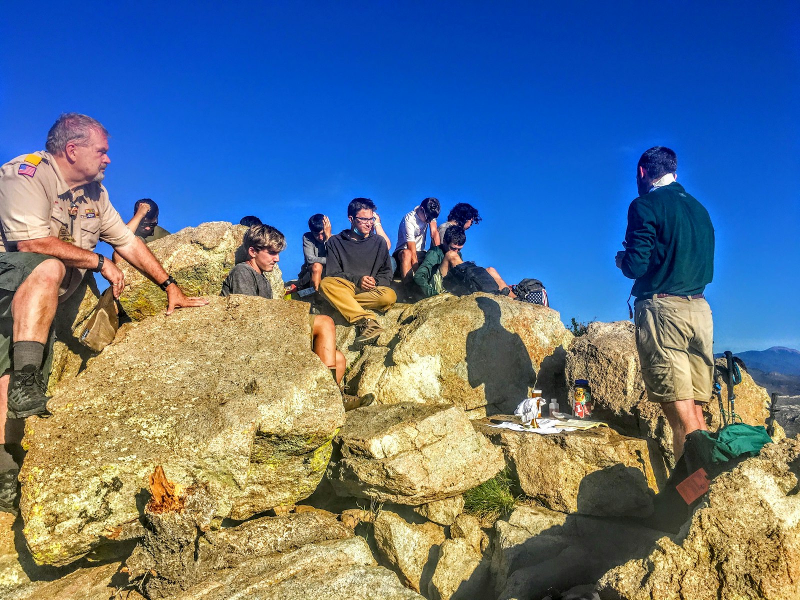 After waking at 3 a.m. to hike to the peak of Tooth of Time at Philmont Scout Ranch in New Mexico, participants in the St. George Trek celebrate Mass together.