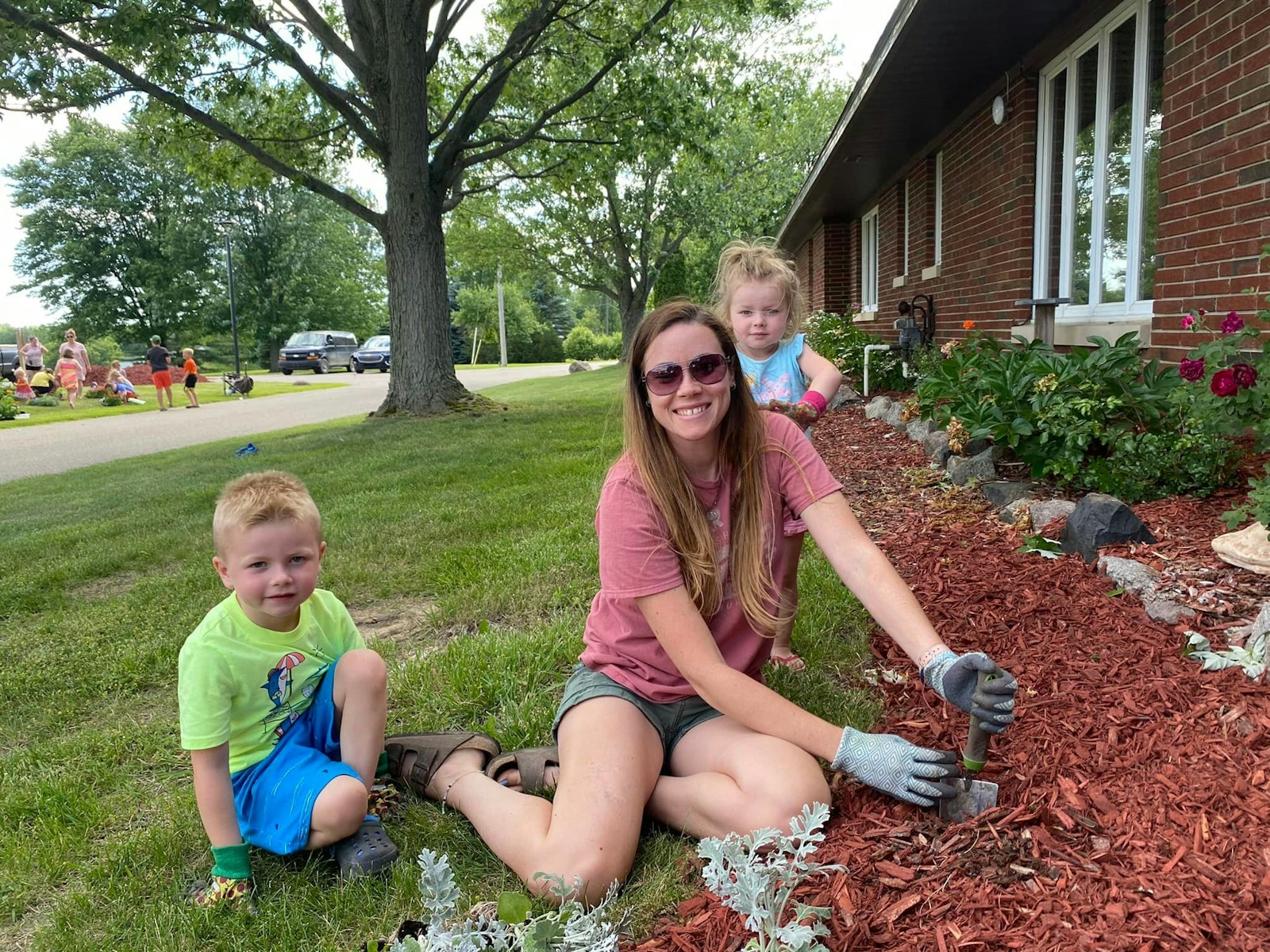 Families help out in the garden at SS. Peter and Paul Parish in North Branch. Fr. Rich Treml, pastor of the four-parish Family of Parishes in northern Lapeer County, said a big focus of their strategic plan is better outreach to families with young children, especially those preparing to baptize their children.
