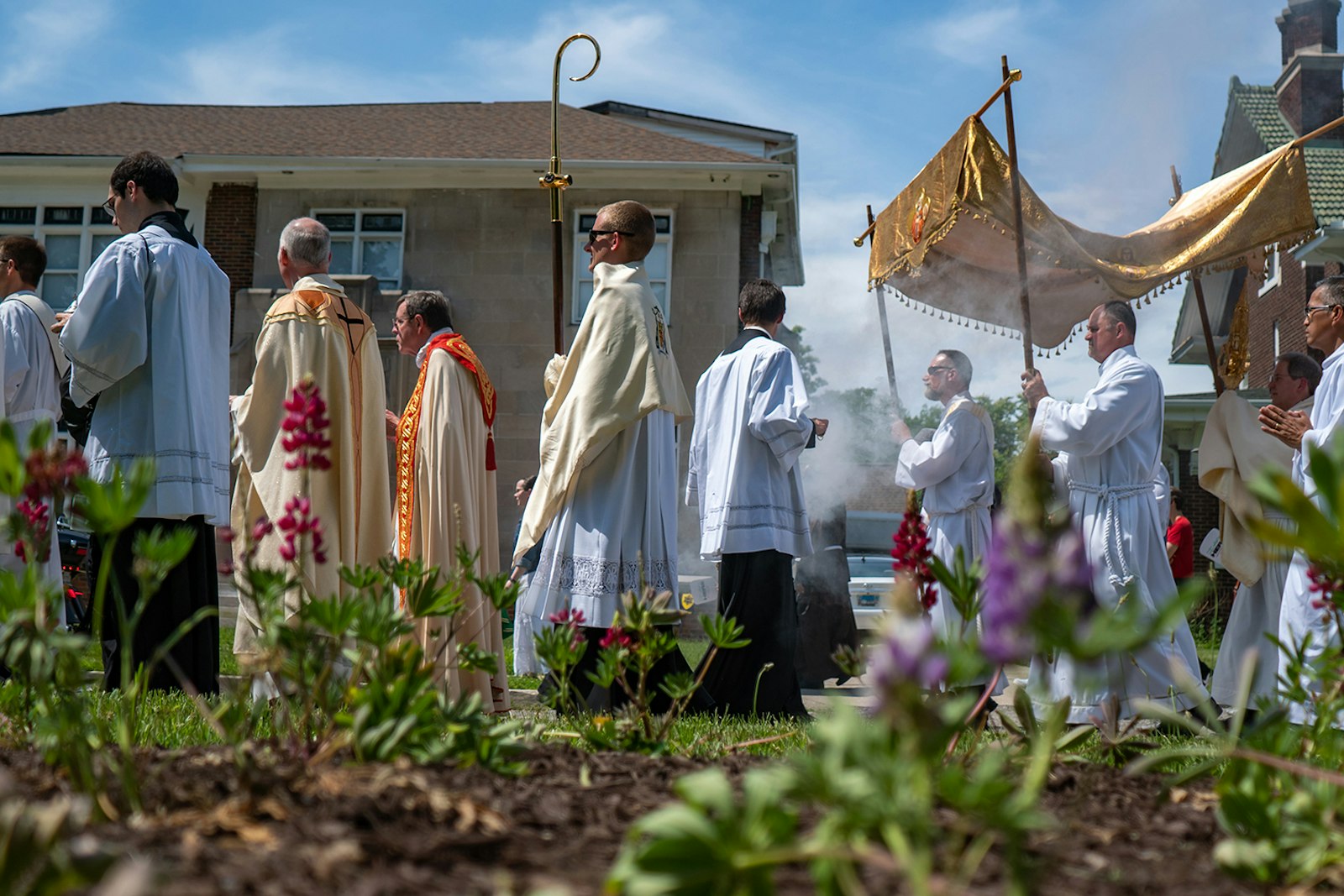 Incense rises ahead of the monstrance as Catholics march in procession with Jesus in the Eucharist along Chicago Boulevard in Detroit. (Matthew Rich | Special to Detroit Catholic)