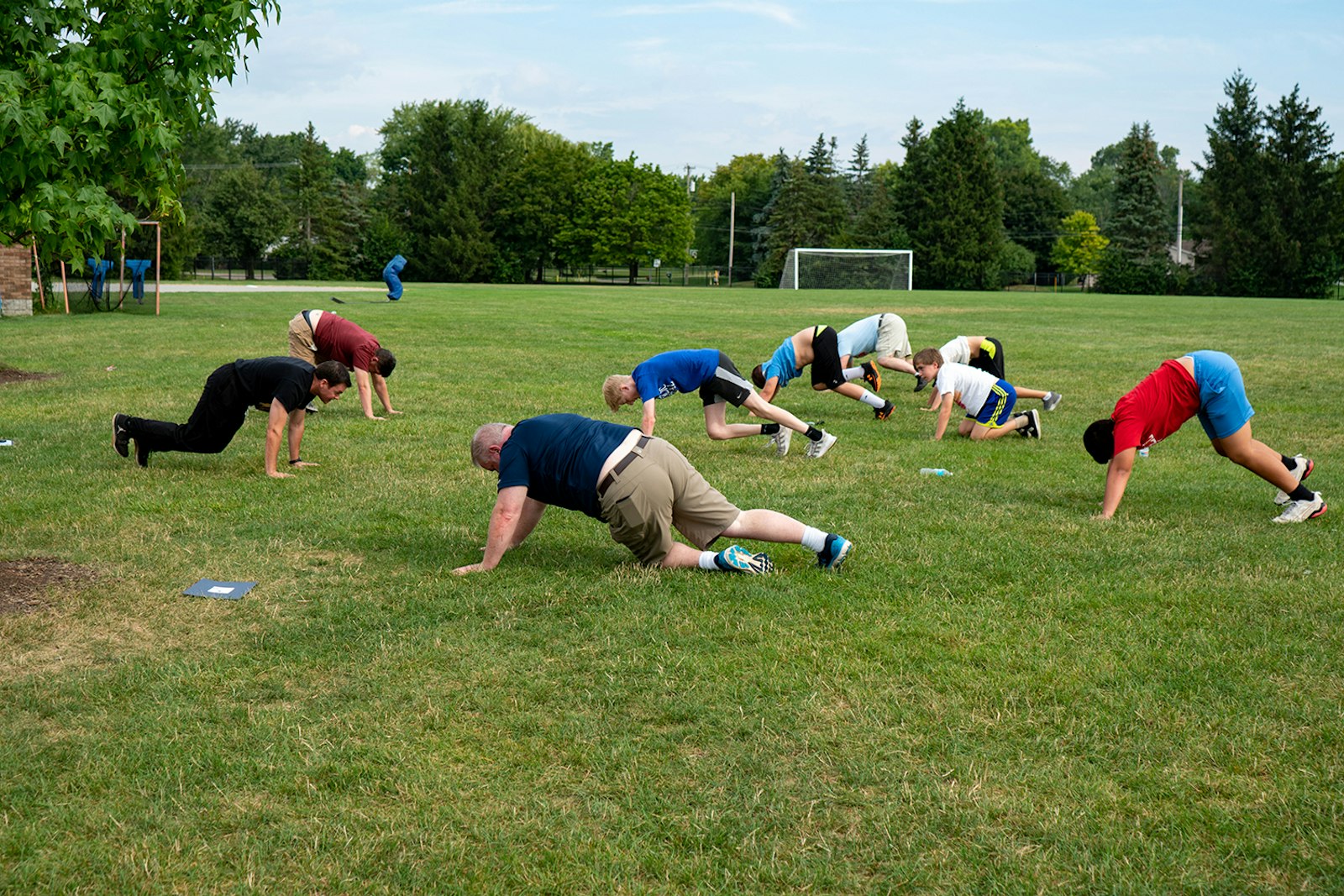 Boys and leaders of the "Exercitus Mariae" youth group do push-ups while praying the rosary Aug. 20. By combining workouts with prayer, leaders say they hope to instill a sense of personal and faith discipline in their young charges.