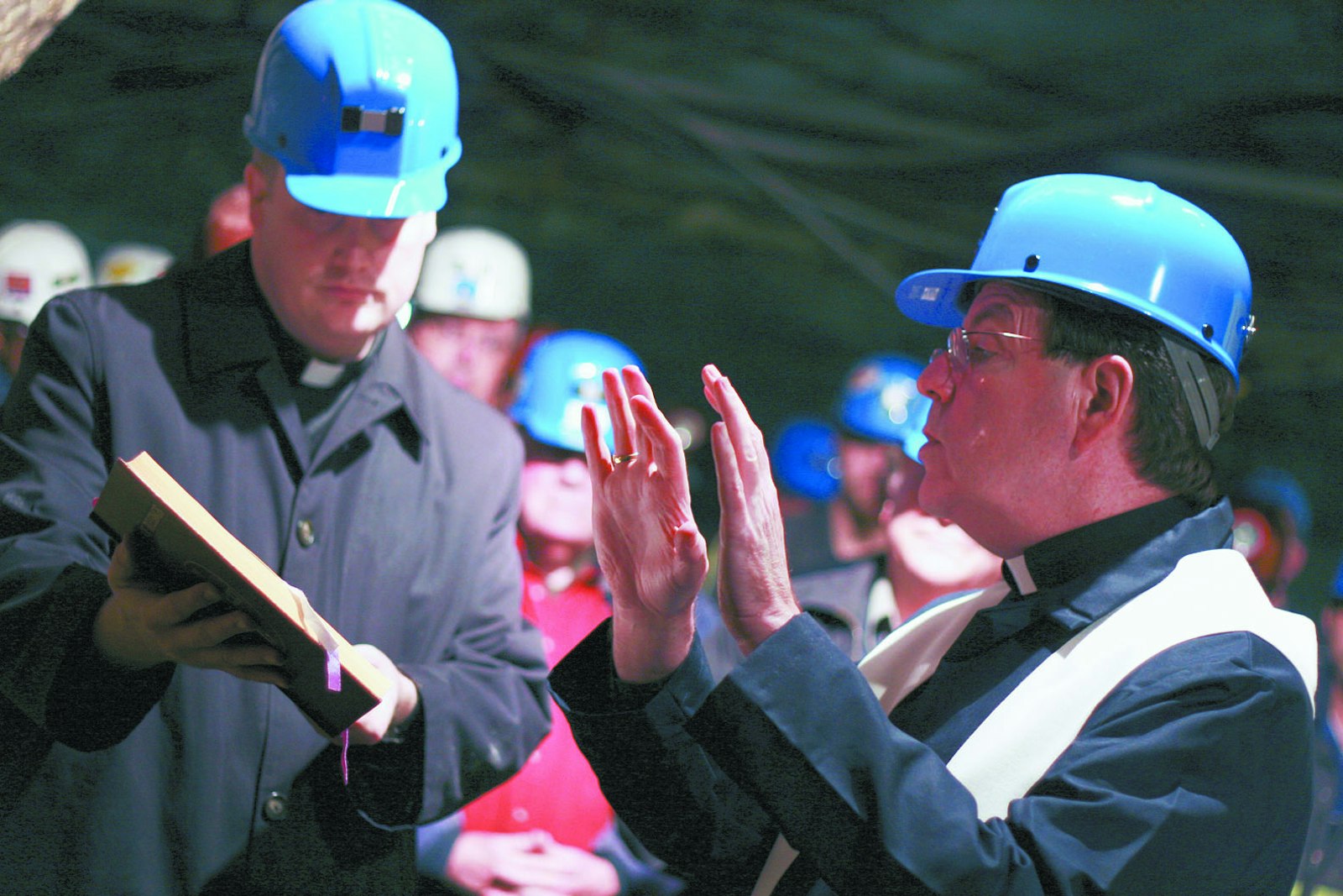 Archbishop Allen H. Vigneron blesses a shrine dedicated to St. Barbara in the Detroit Salt Mine on Oct. 22, 2009, as Fr. Charles Fox, then priest-secretary to the archbishop, assists. (Jared Field | Michigan Catholic file photo)