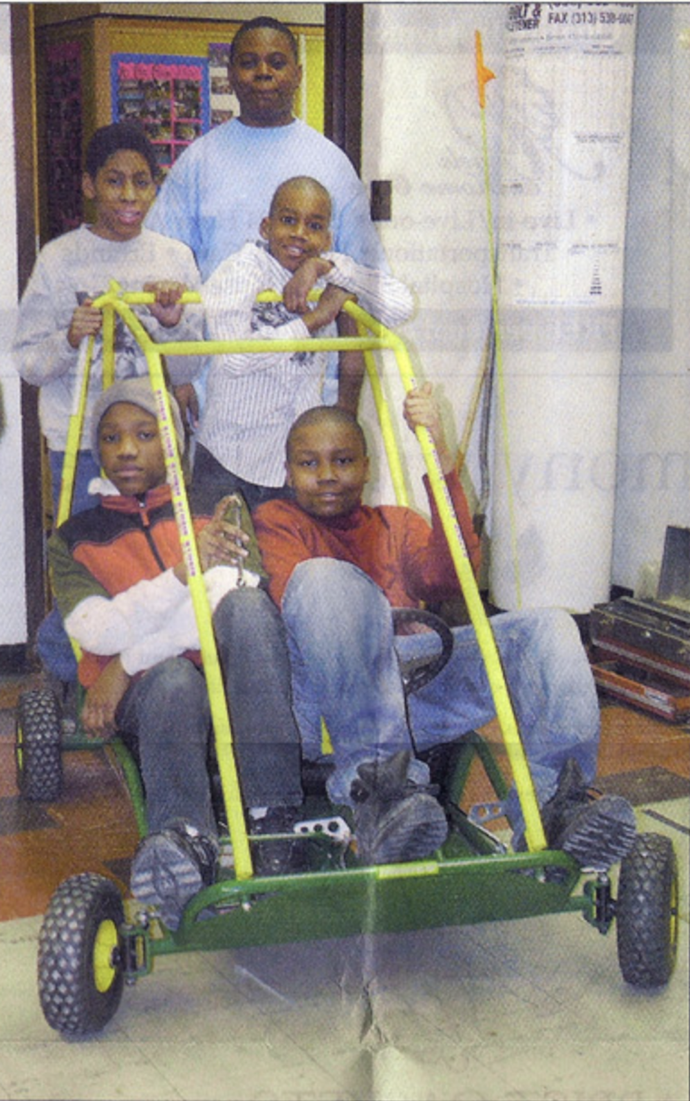 A photo from the Michigan Catholic archives provided by Deacon Delbeke shows members of the Tuskegee Spirits with a car they built.