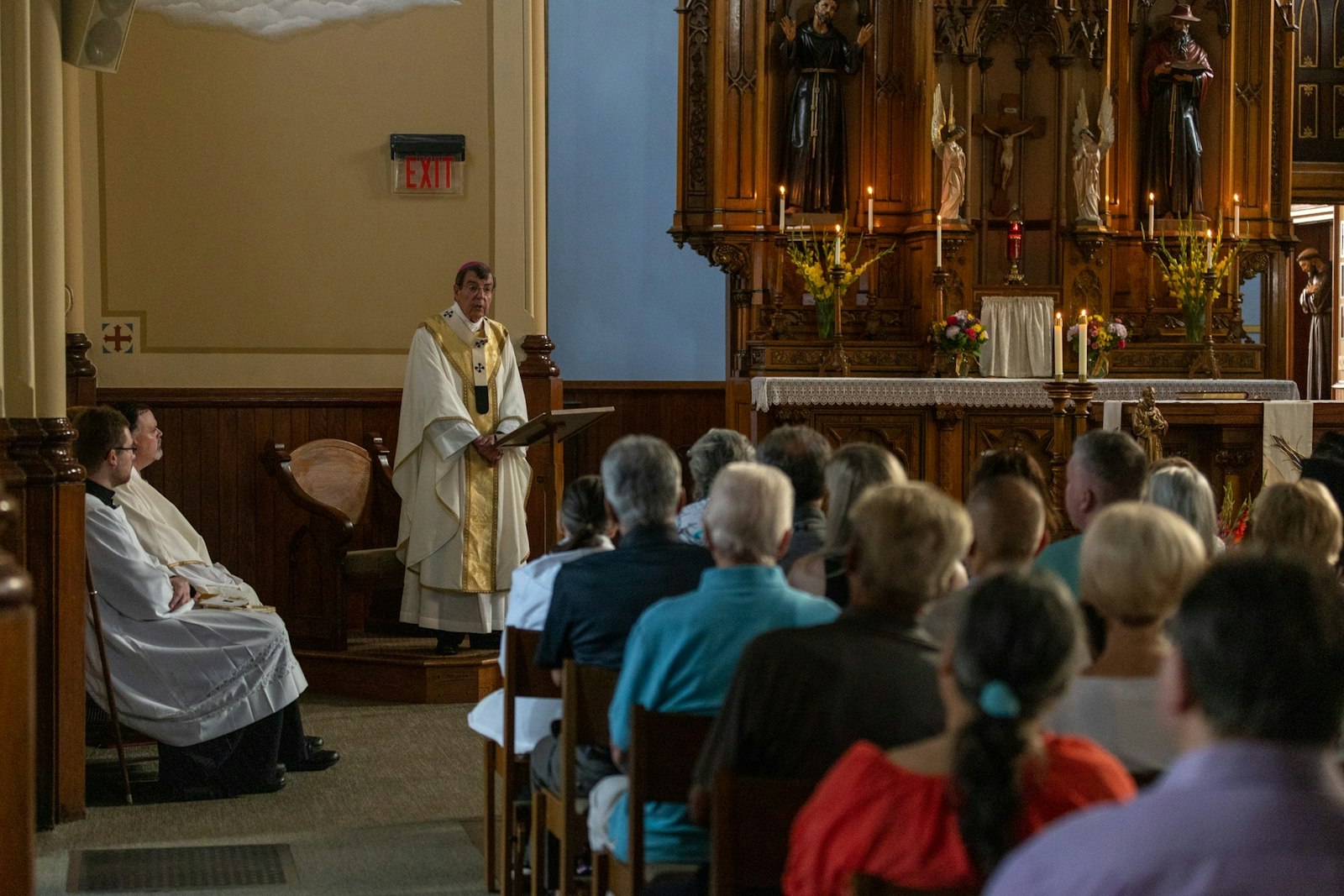 Archbishop Vigneron delivers his homily by candlelight in the chapel of St. Bonaventure Monastery. Wisdom, the archbishop said, is not about having worldly knowledge or technical expertise, but the ability to see God's will in all things, as Blessed Solanus Casey had. Blessed Solanus' feast day is July 30, the day before the anniversary of the friar's death in 1957.