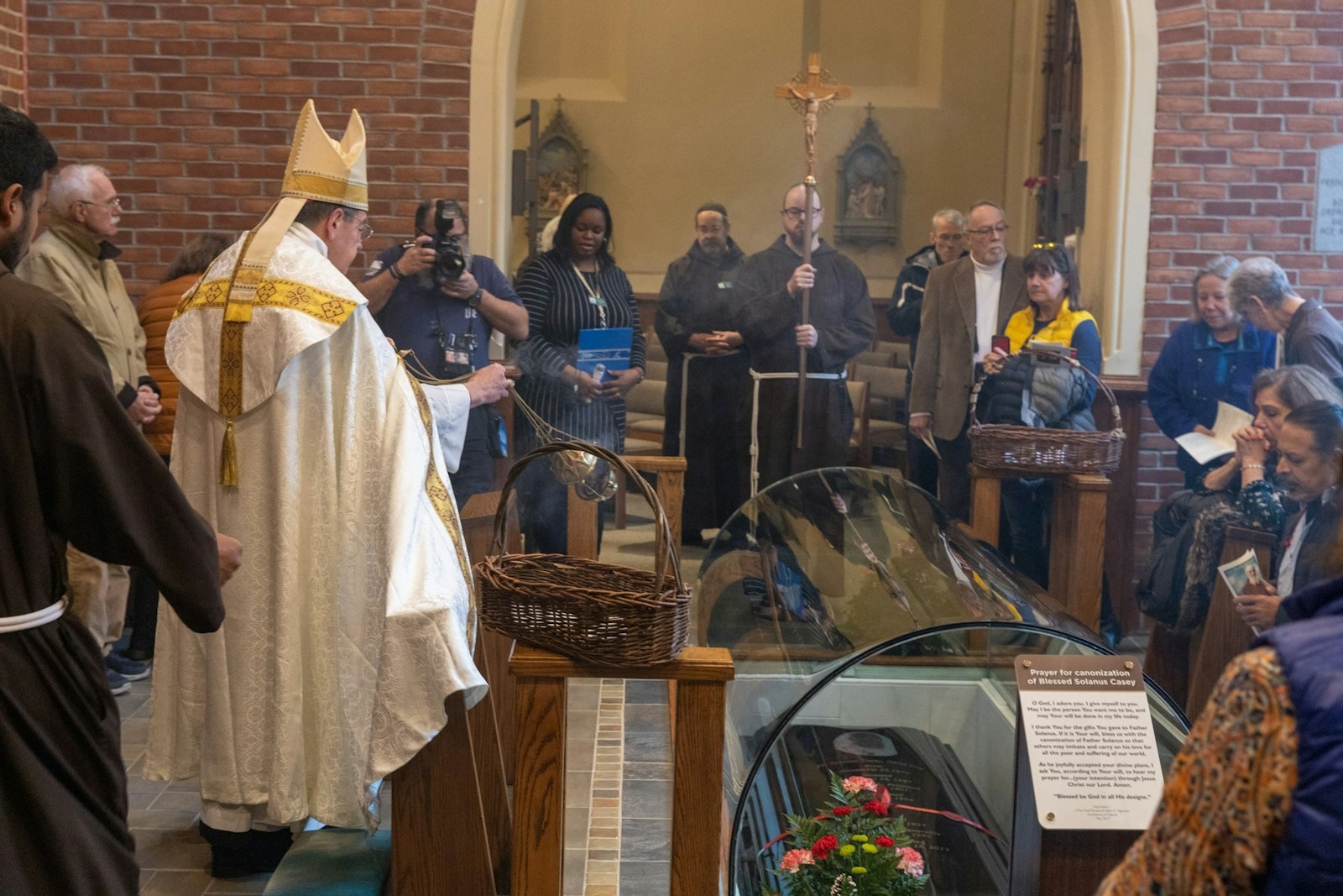Archbishop Vigneron blesses the tomb of Blessed Solanus Casey during a celebration of the Solanus Casey Center's 20th anniversary Dec. 3.