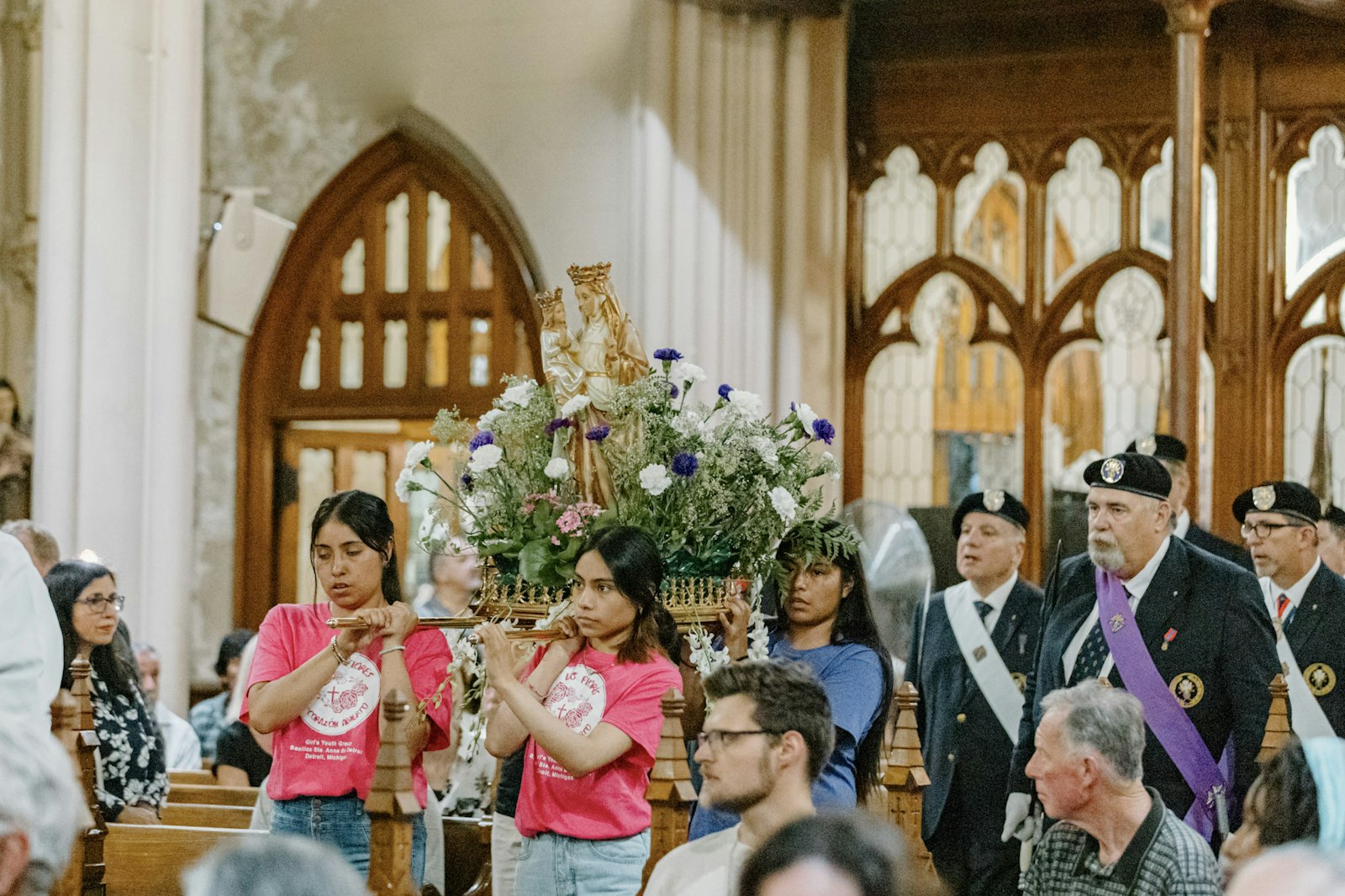 Parishioners carry a statue of St. Anne in procession during the start of Mass. After Mass, attendees had an opportunity to venerate a first-class relic of the grandmother of Jesus.