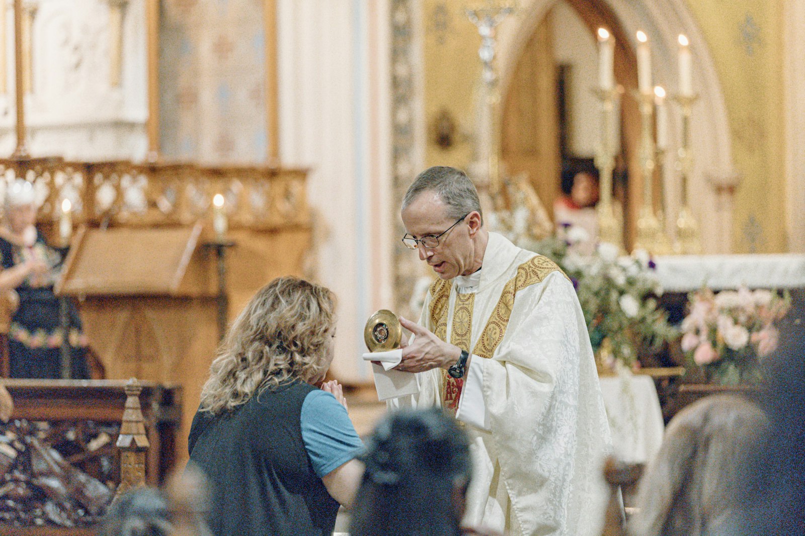 Fr. John Herman, CSC, a priest serving at the Basilica of Ste. Anne, offers a first-class relic of St. Anne for veneration after Mass.