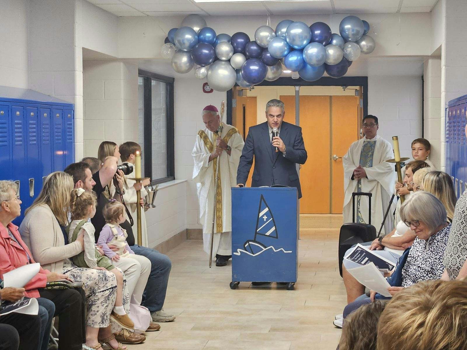 St. Edward on the Lake School principal Denis Metty addresses parents, teachers, students and staff during a ceremonial ribbon cutting and blessing of six new classrooms Sept. 6.