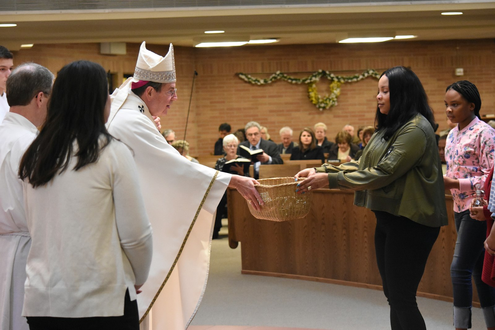 Archbishop Allen H. Vigneron greets parishioners during Mass at St. Fabian Parish in Farmington Hills on April 15, 2018. The archbishop spoke during his homily about the victory of Christ over the evils of sin, specifically racism, and to call for Catholics to fight every form of prejudice and hatred. (Naomi Vrazo | Archdiocese of Detroit)