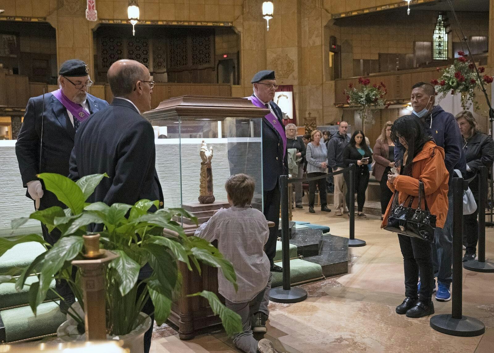 As they venerated the relic of St. Jude, many people pressed rosaries, prayer cards and other items to the glass reliquary, asking the saint to intercede for them, their families and friends.